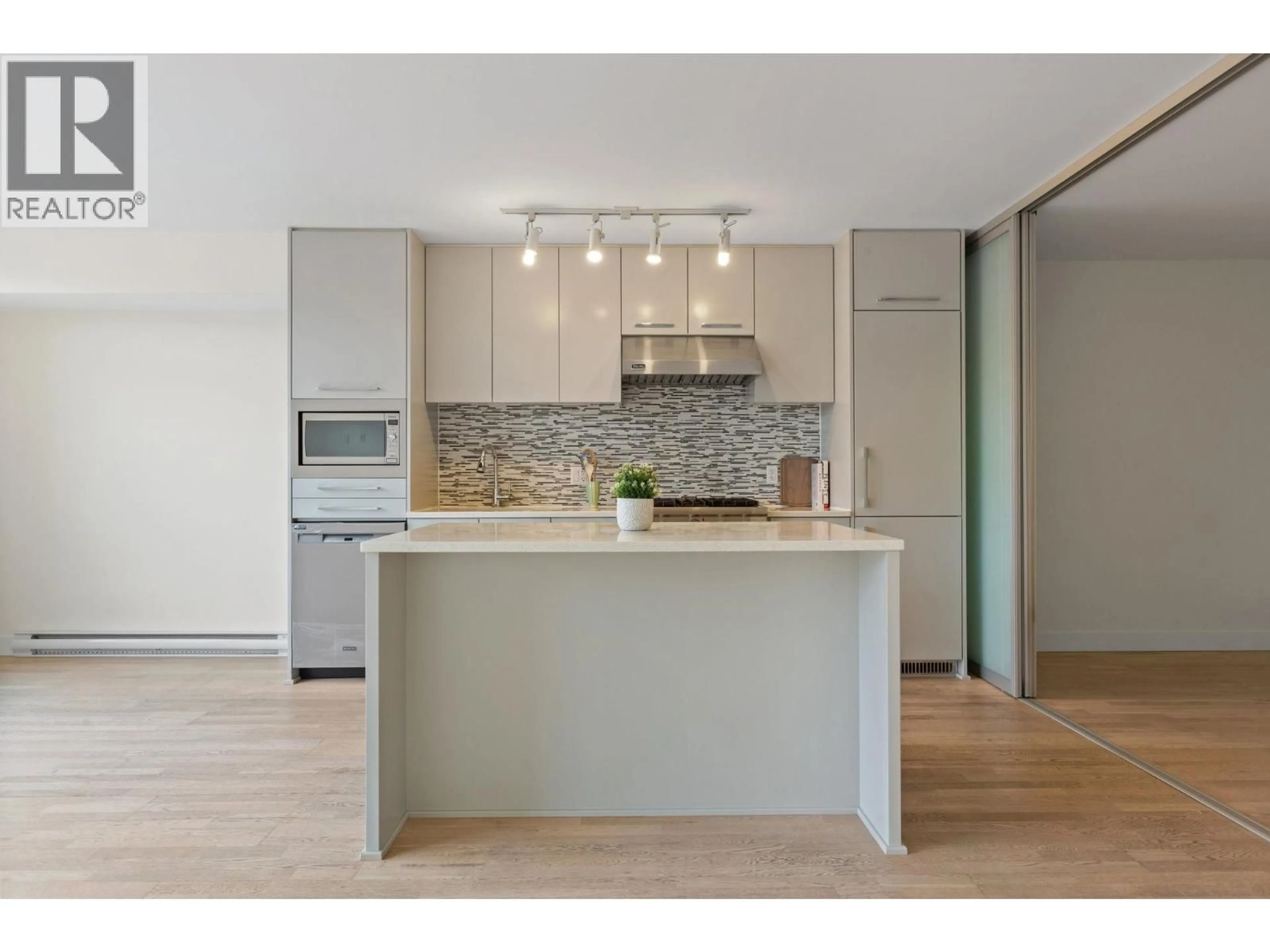 Open concept kitchen, wood/laminate floor for 306 - 4355 10TH AVENUE, Vancouver British Columbia V6R2H6