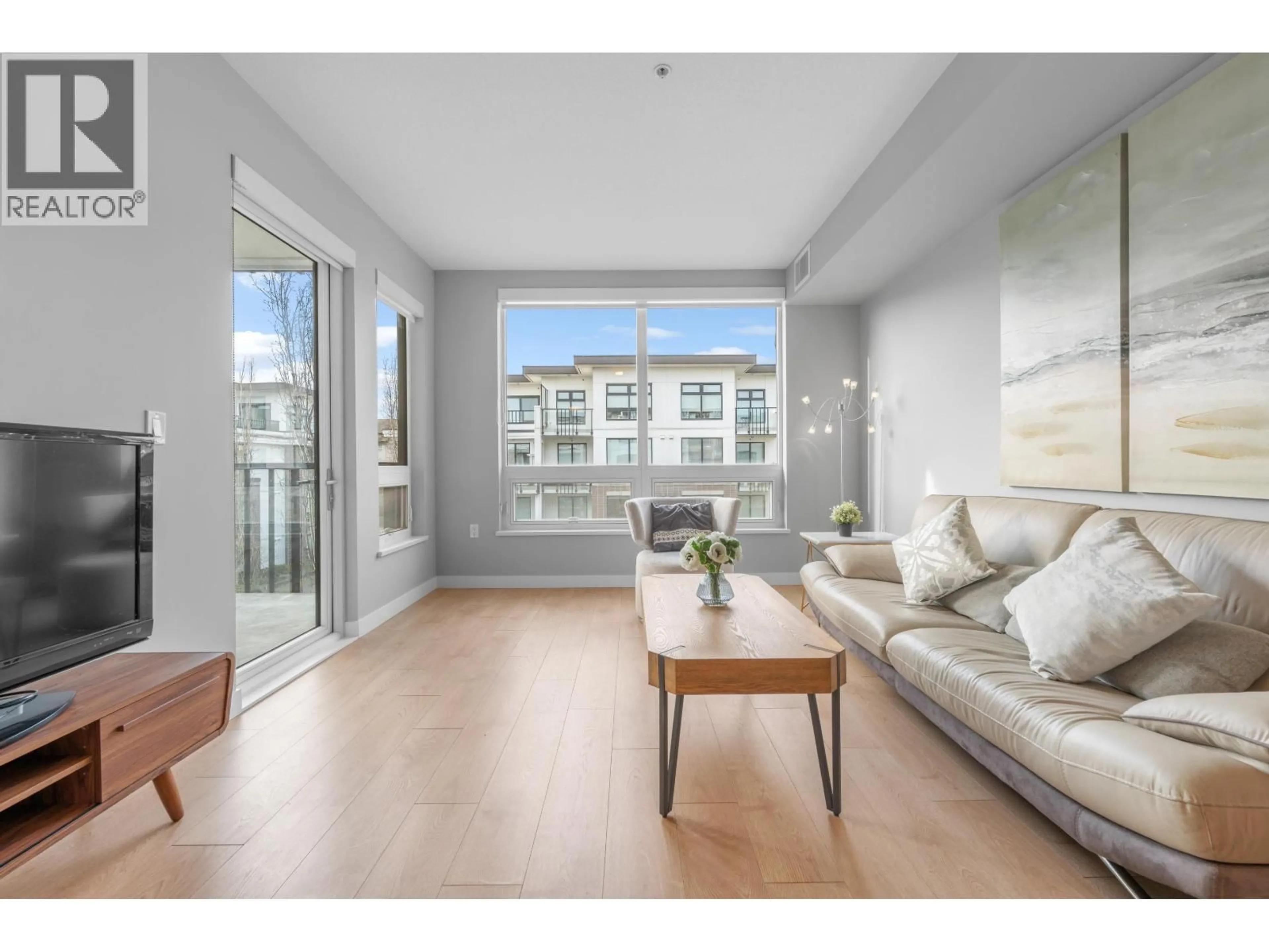 Living room with furniture, wood/laminate floor for 311 - 9388 ODLIN ROAD, Richmond British Columbia V6X0L5