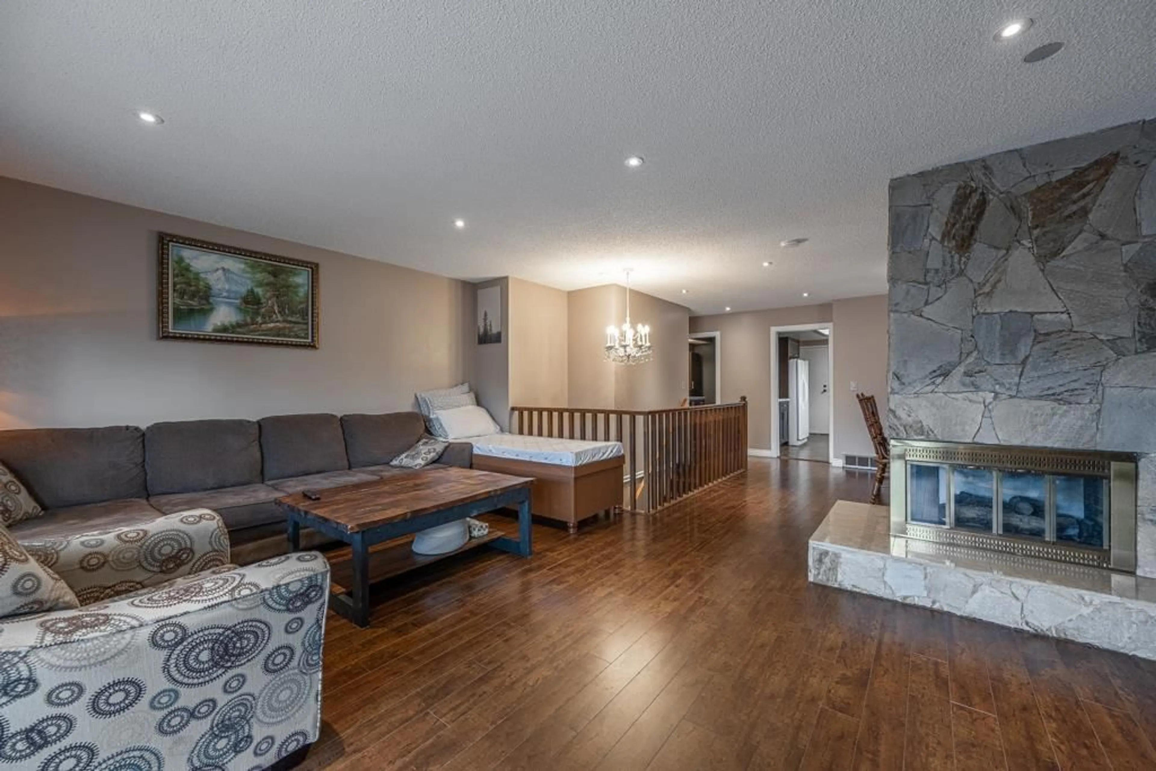 Living room with furniture, wood/laminate floor for 6478 130 STREET, Surrey British Columbia V3W4J1