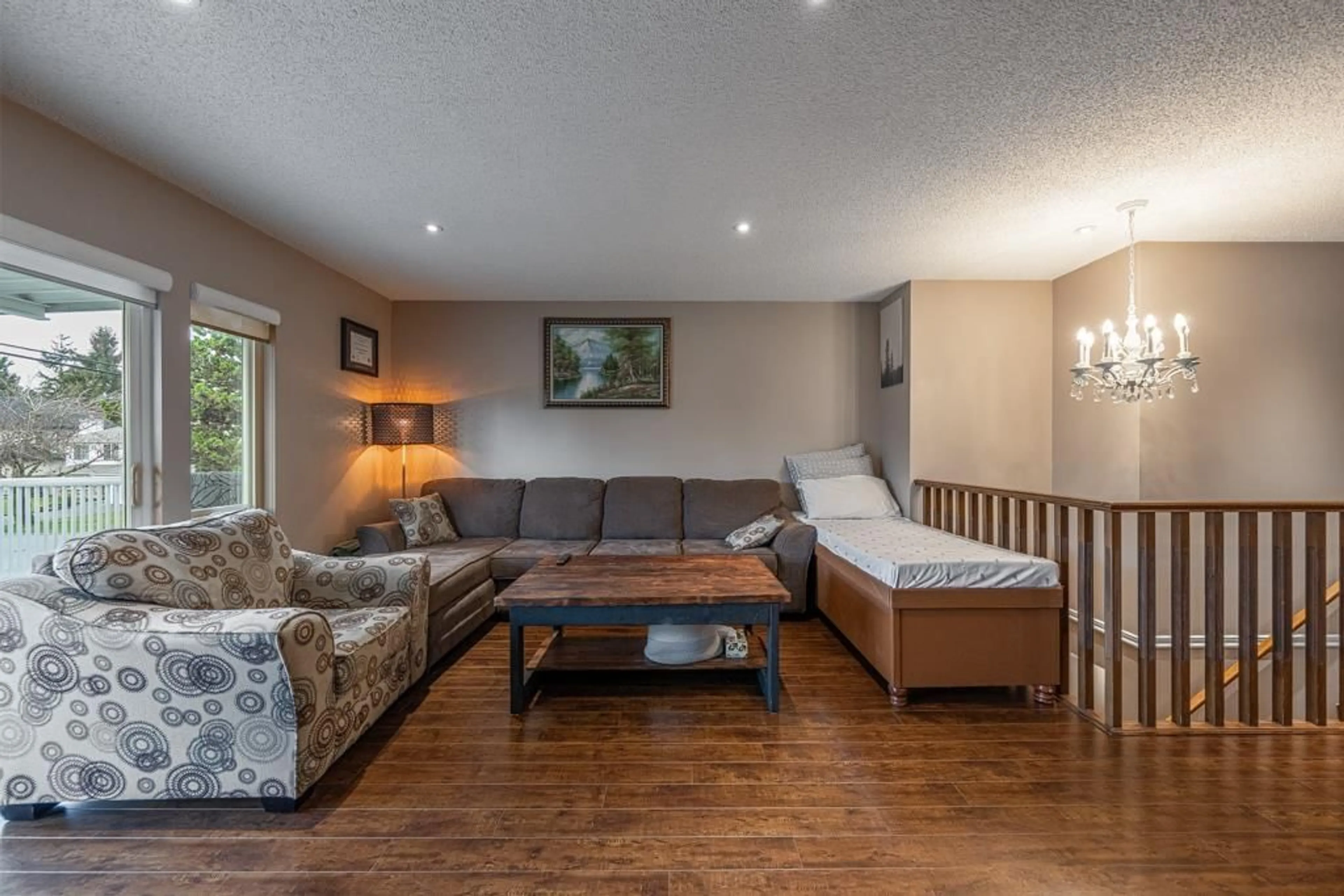 Living room with furniture, wood/laminate floor for 6478 130 STREET, Surrey British Columbia V3W4J1