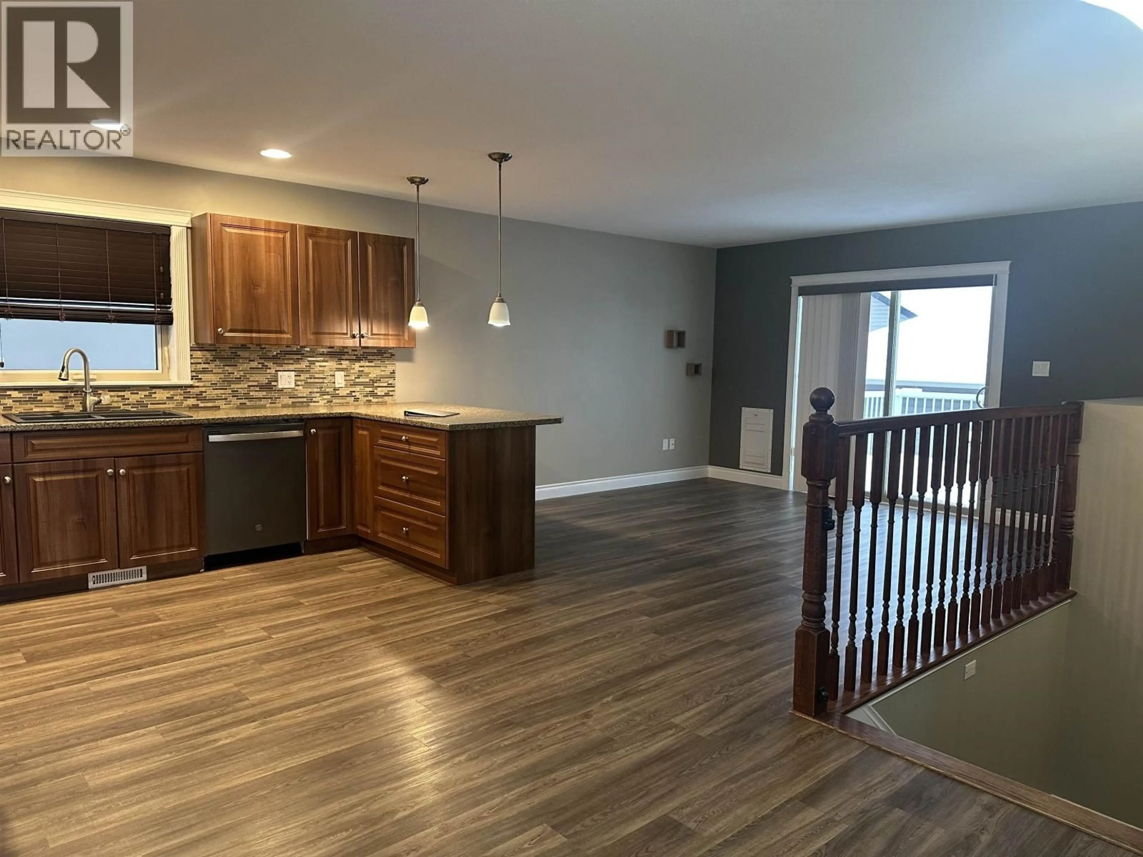 Open concept kitchen, wood/laminate floor for 8623 114 AVENUE, Fort St. John British Columbia V1J0C3
