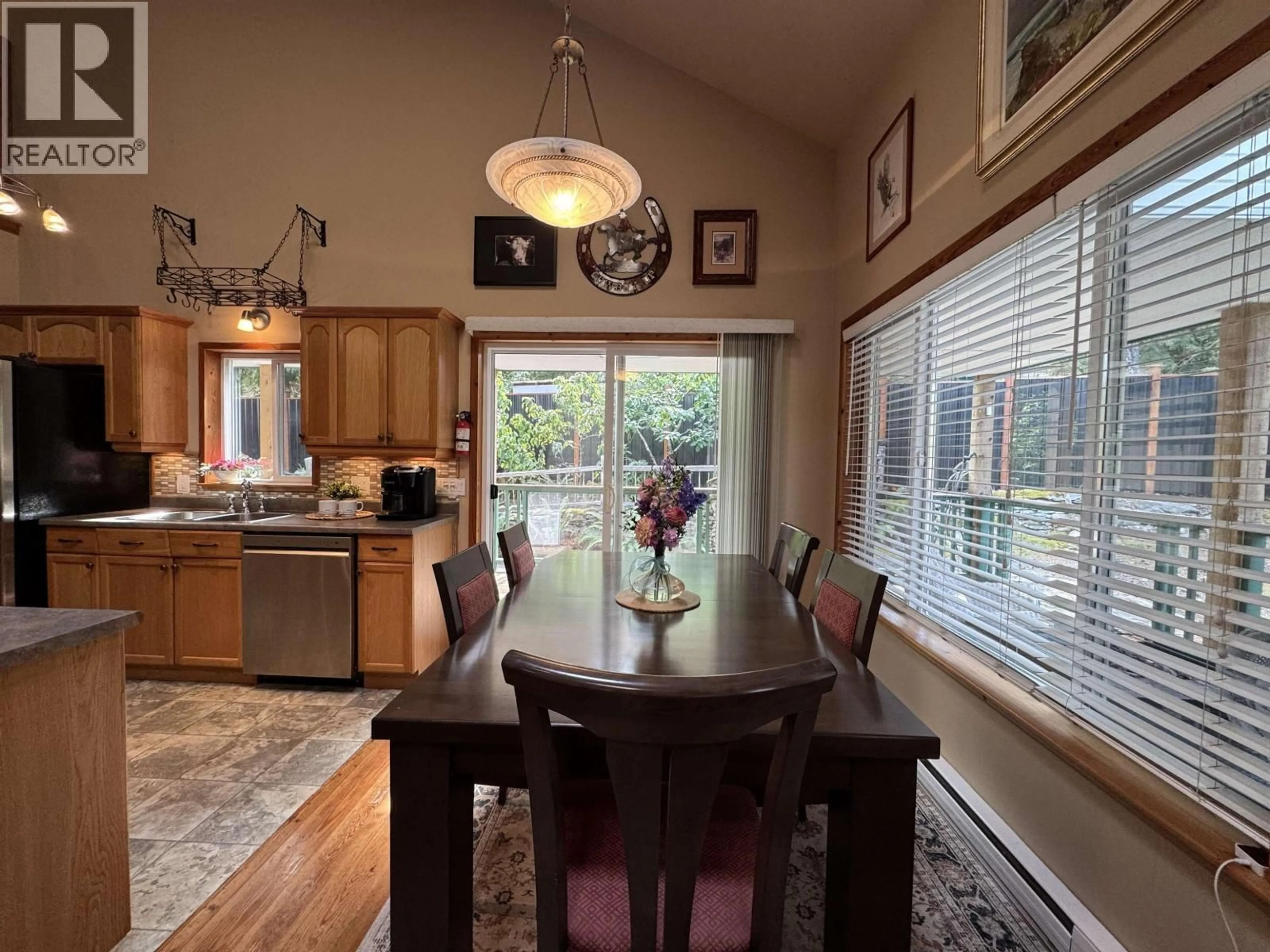 Open concept kitchen, wood/laminate floor for 714 CHARTER ROAD, Mayne Island British Columbia V0N2J1