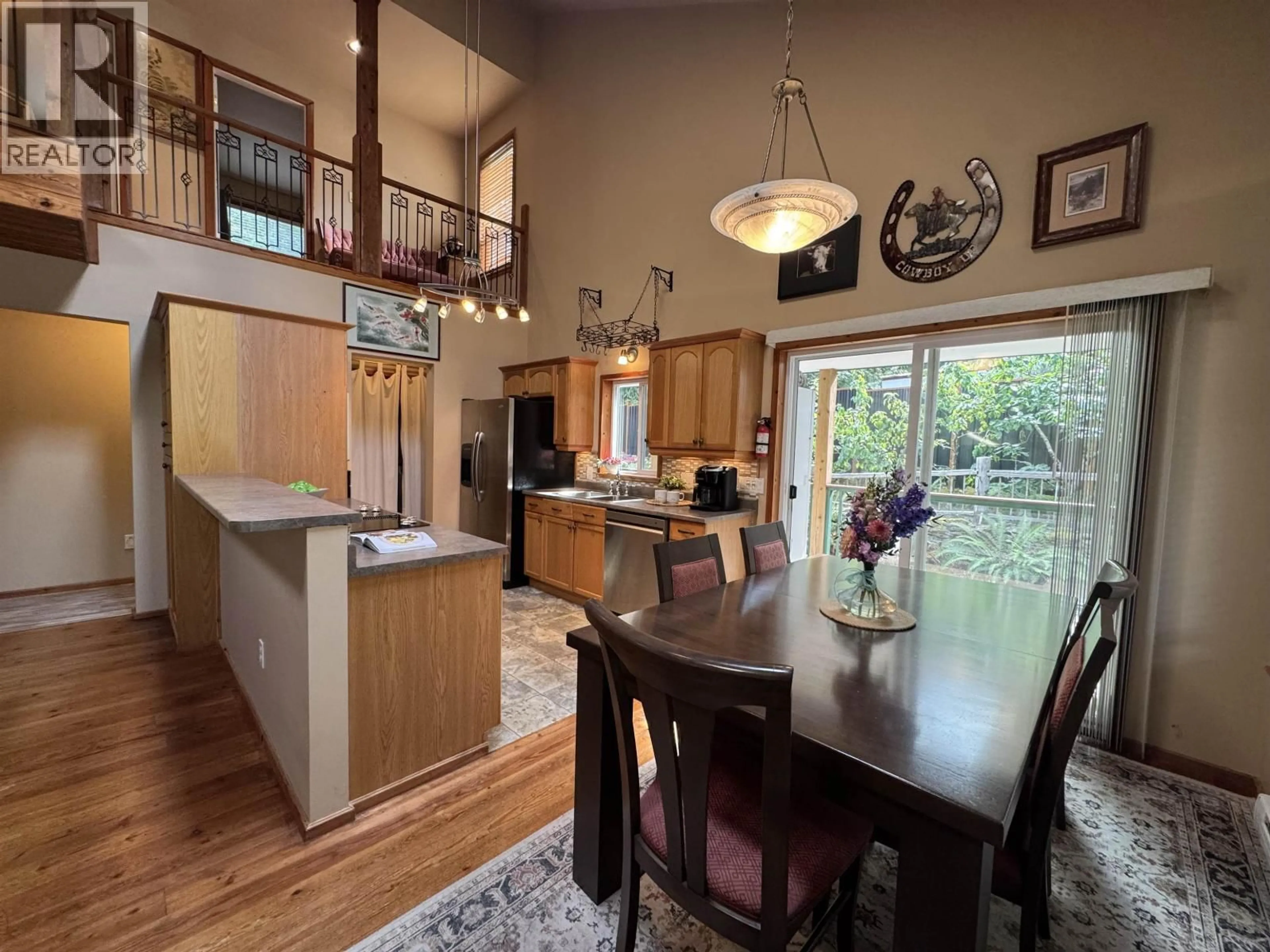 Open concept kitchen, wood/laminate floor for 714 CHARTER ROAD, Mayne Island British Columbia V0N2J1