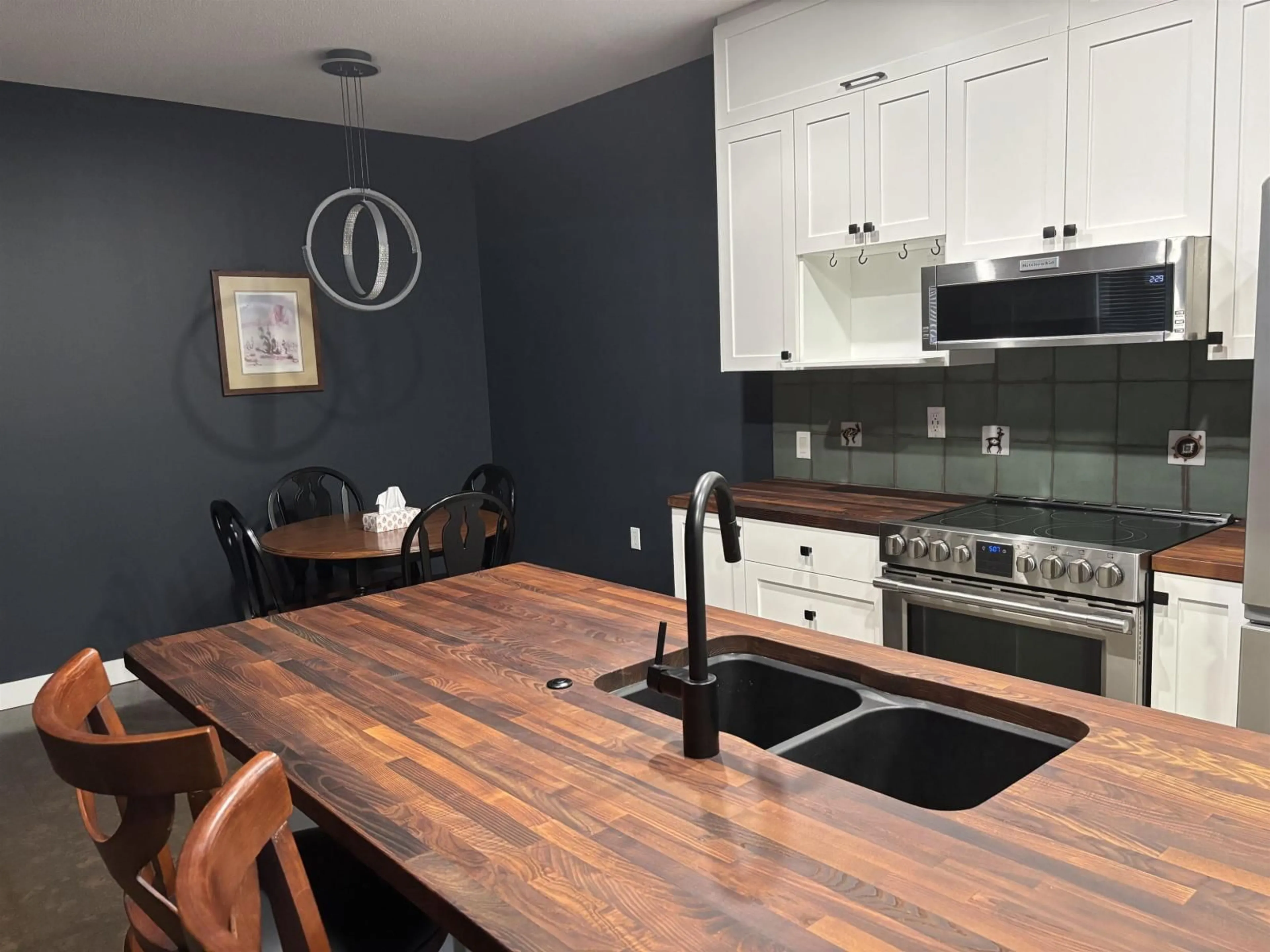 Open concept kitchen, wood/laminate floor for 413 - 8880 202 STREET, Langley British Columbia V1M4E7