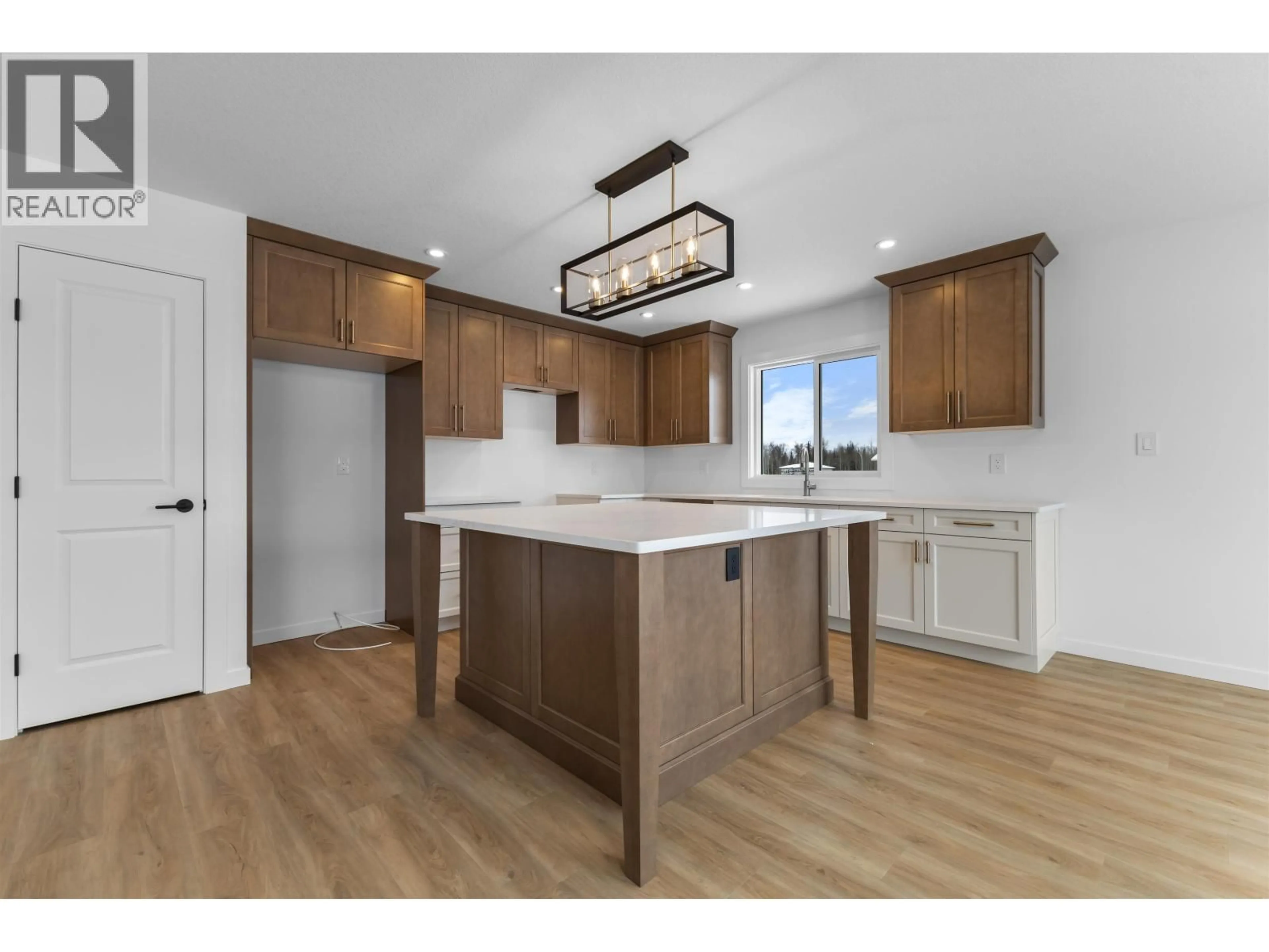 Open concept kitchen, wood/laminate floor for 5305 BREANNA AVENUE, Prince George British Columbia V2K0B6