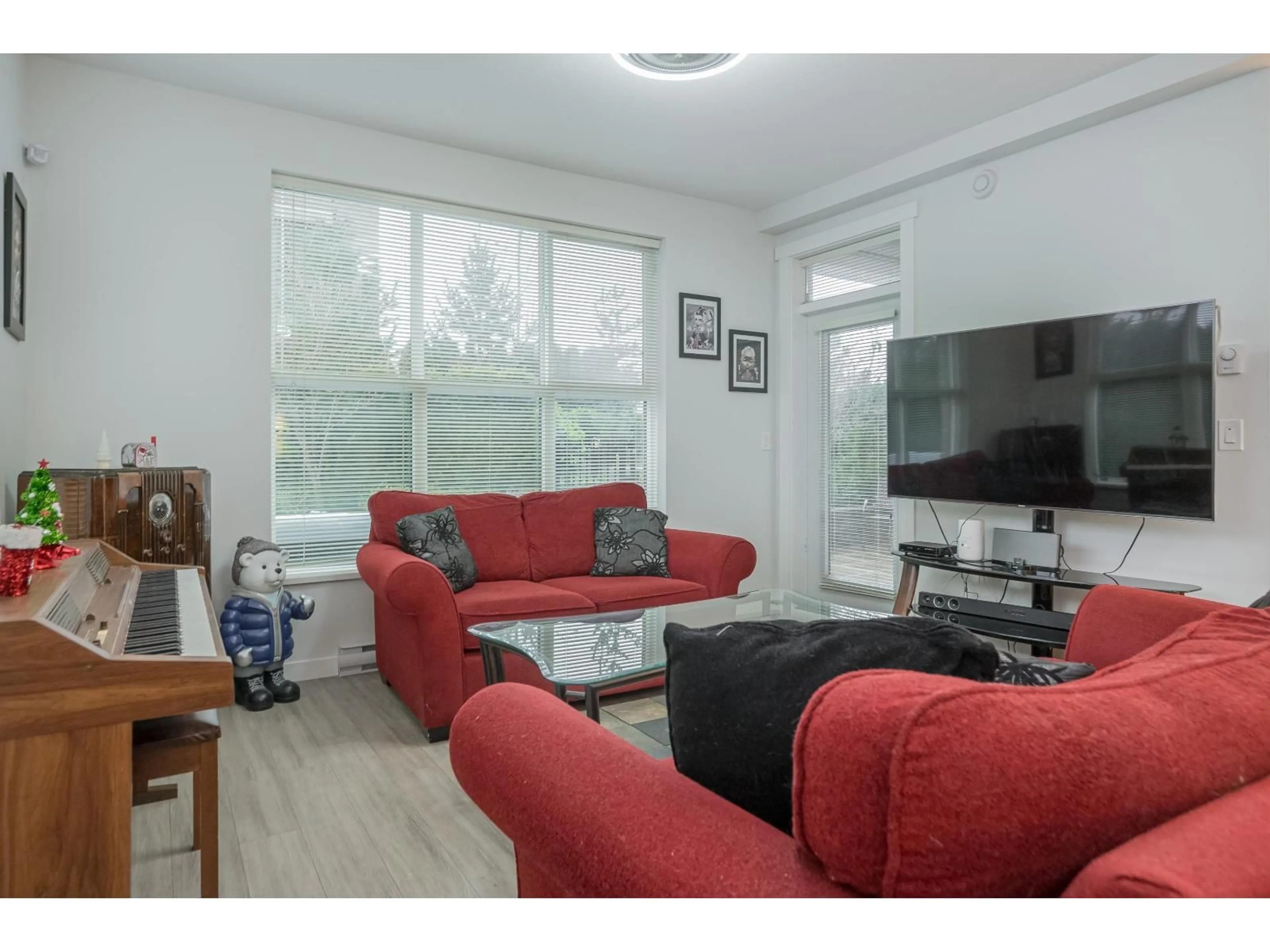 Living room with furniture, wood/laminate floor for B116 - 8150 207 STREET, Langley British Columbia V2Y4J3