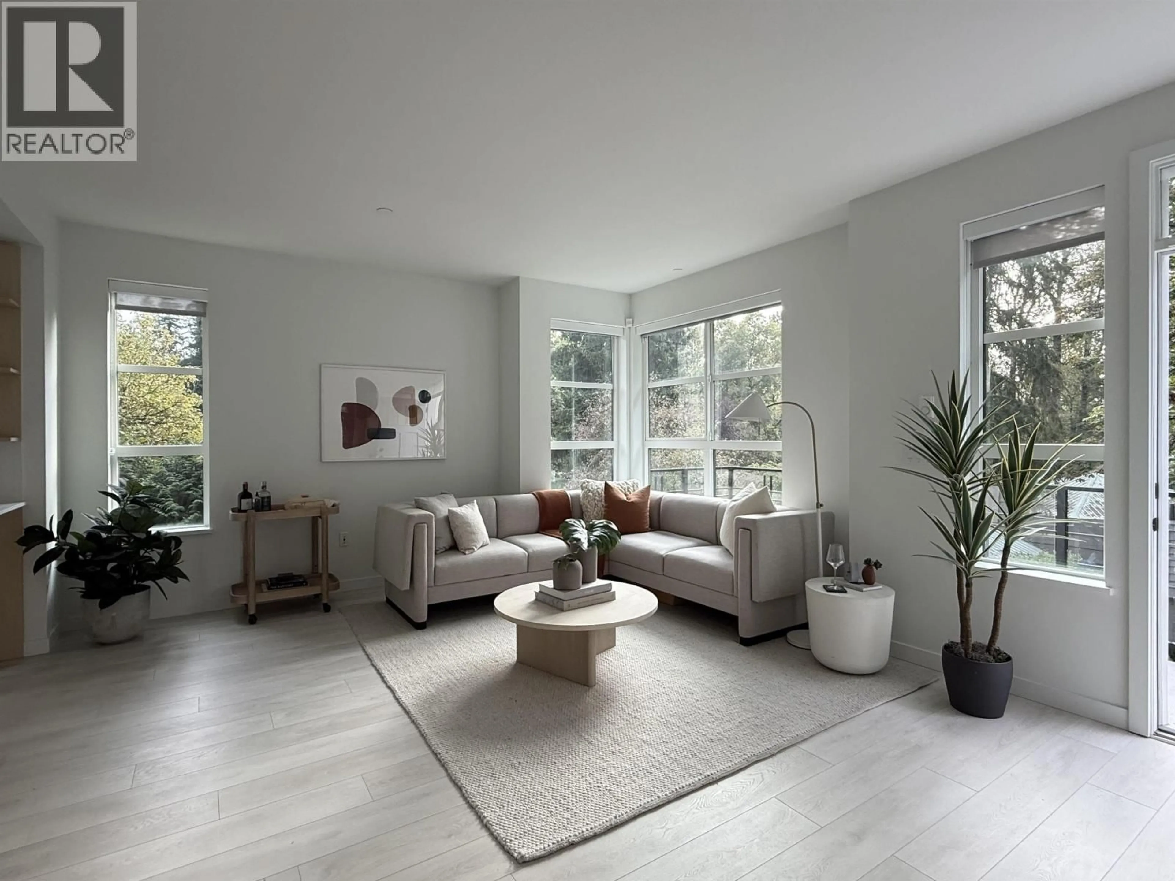 Living room with furniture, unknown for 210 - 2045 HERITAGE PARK LANE, North Vancouver British Columbia V7H0E3