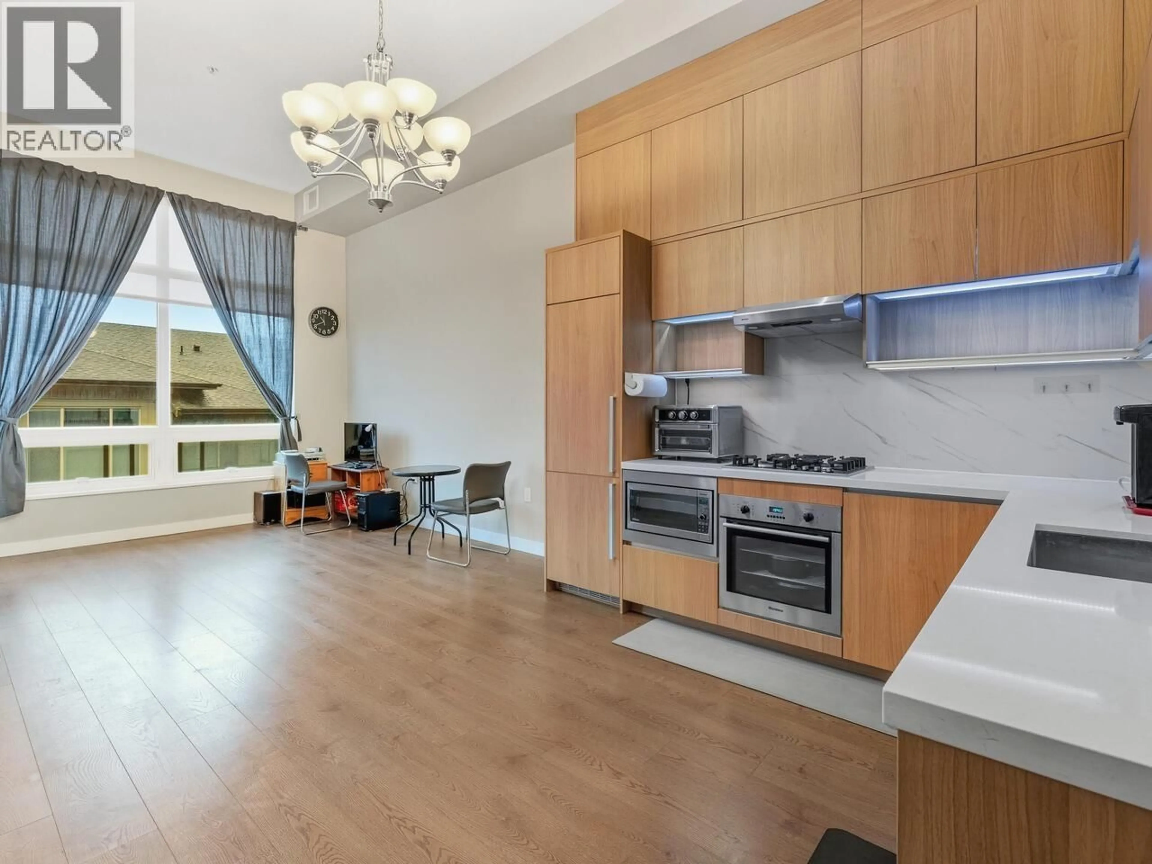 Open concept kitchen, wood/laminate floor for 408 - 9333 TOMICKI AVENUE, Richmond British Columbia V6X0L4