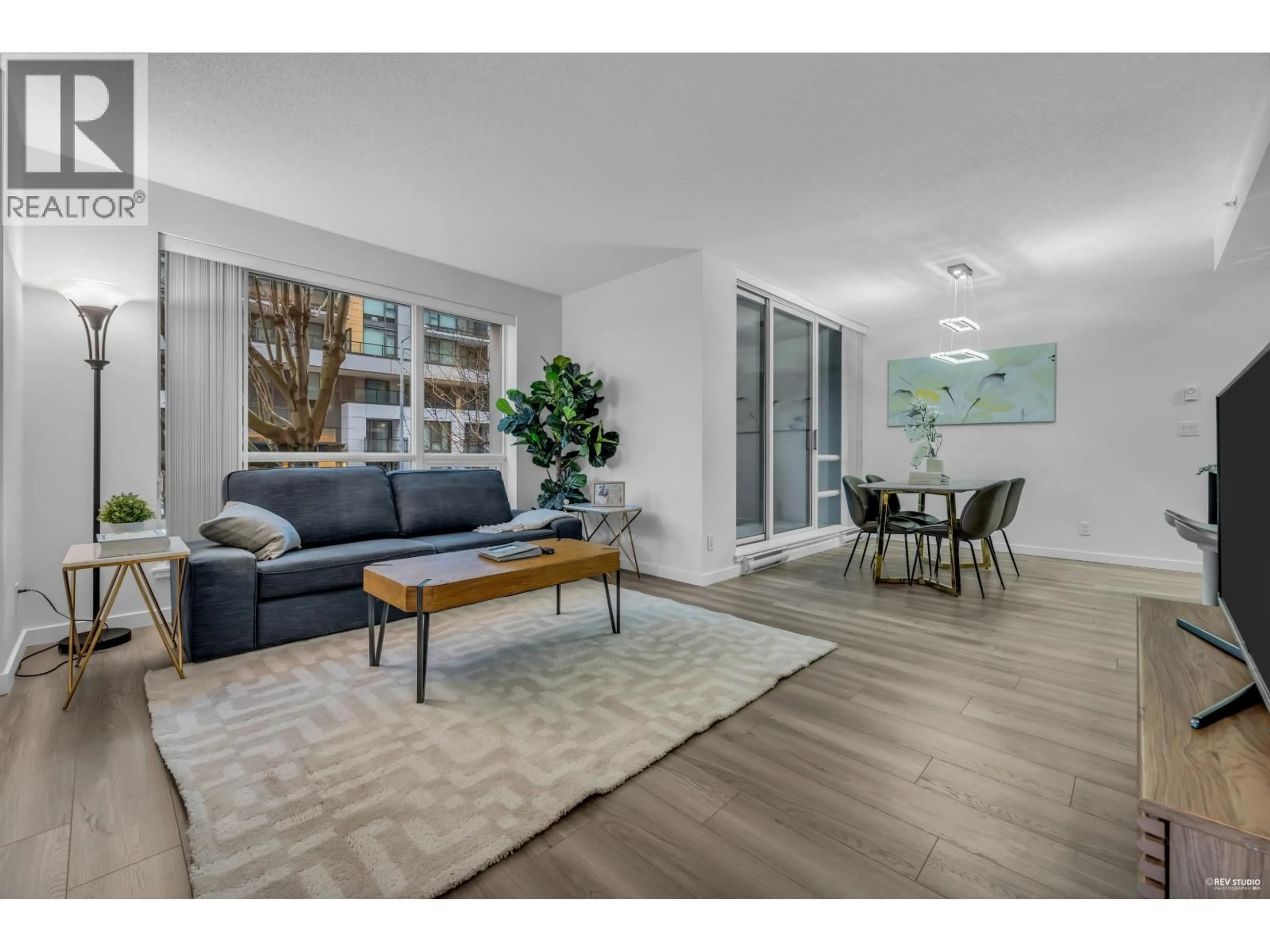 Living room with furniture, wood/laminate floor for 201 - 3111 CORVETTE WAY, Richmond British Columbia V6X4K3