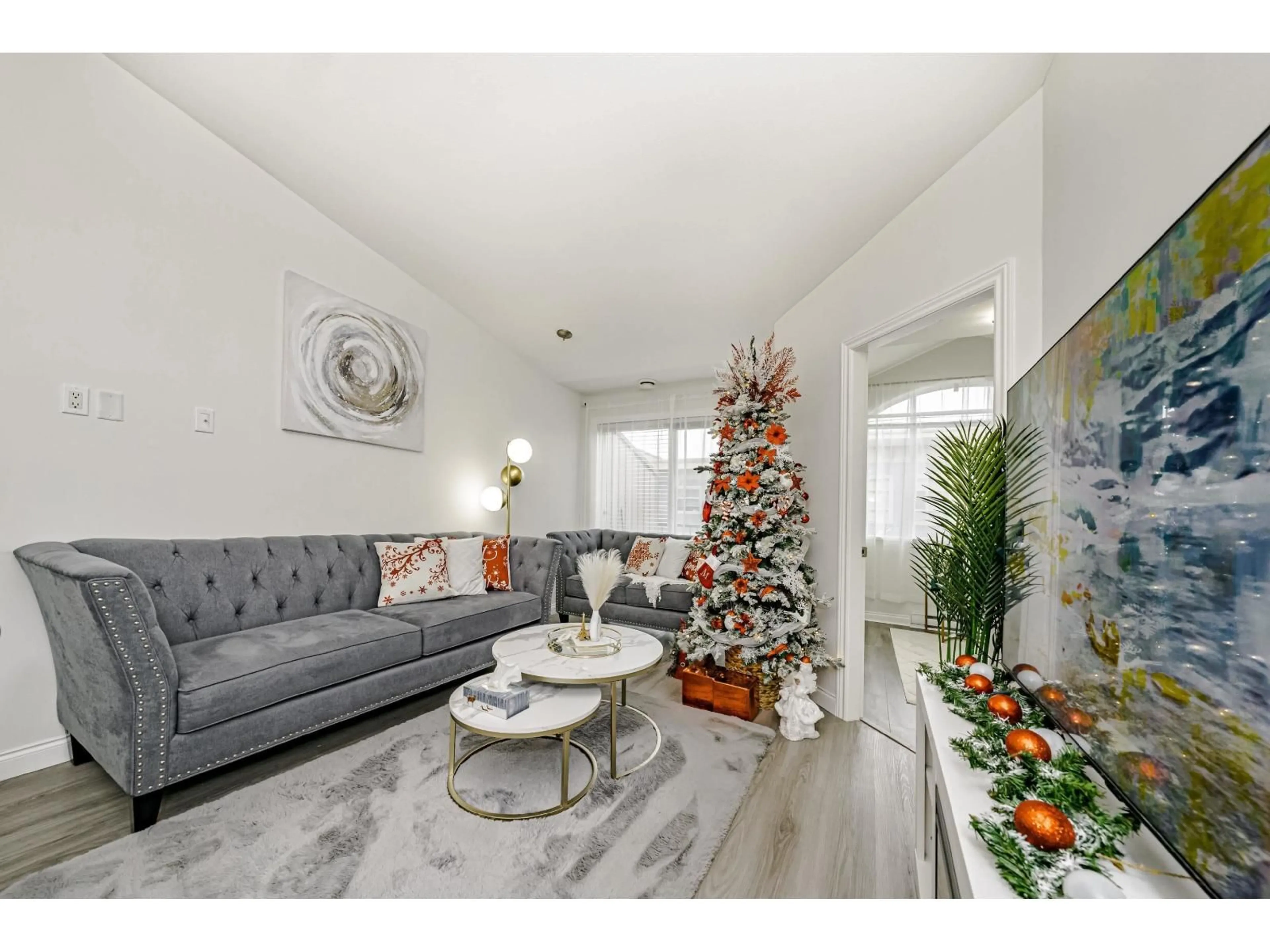 Living room with furniture, wood/laminate floor for 409 - 19939 55A AVENUE AVENUE, Langley British Columbia V3A3X4