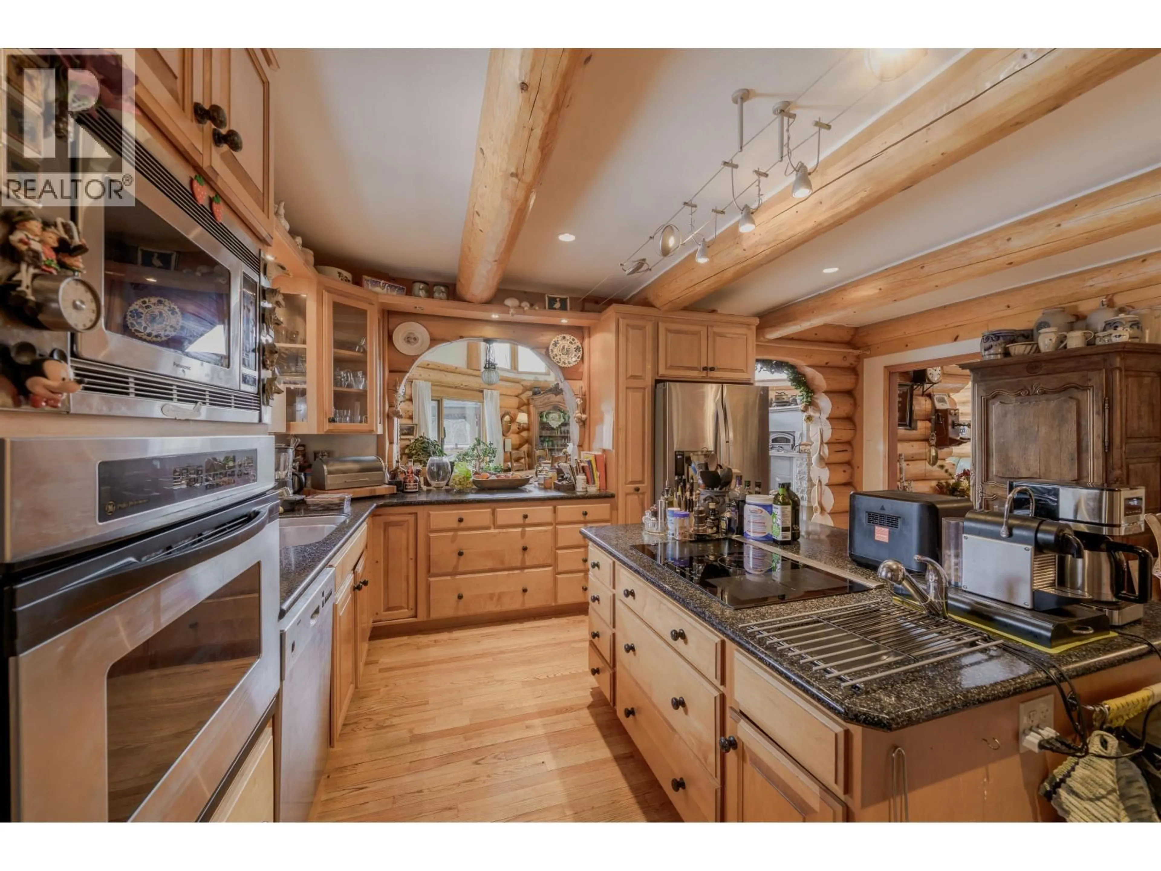 Open concept kitchen, wood/laminate floor for 5565 BACKVALLEY ROAD, 100 Mile House British Columbia V0K2E1