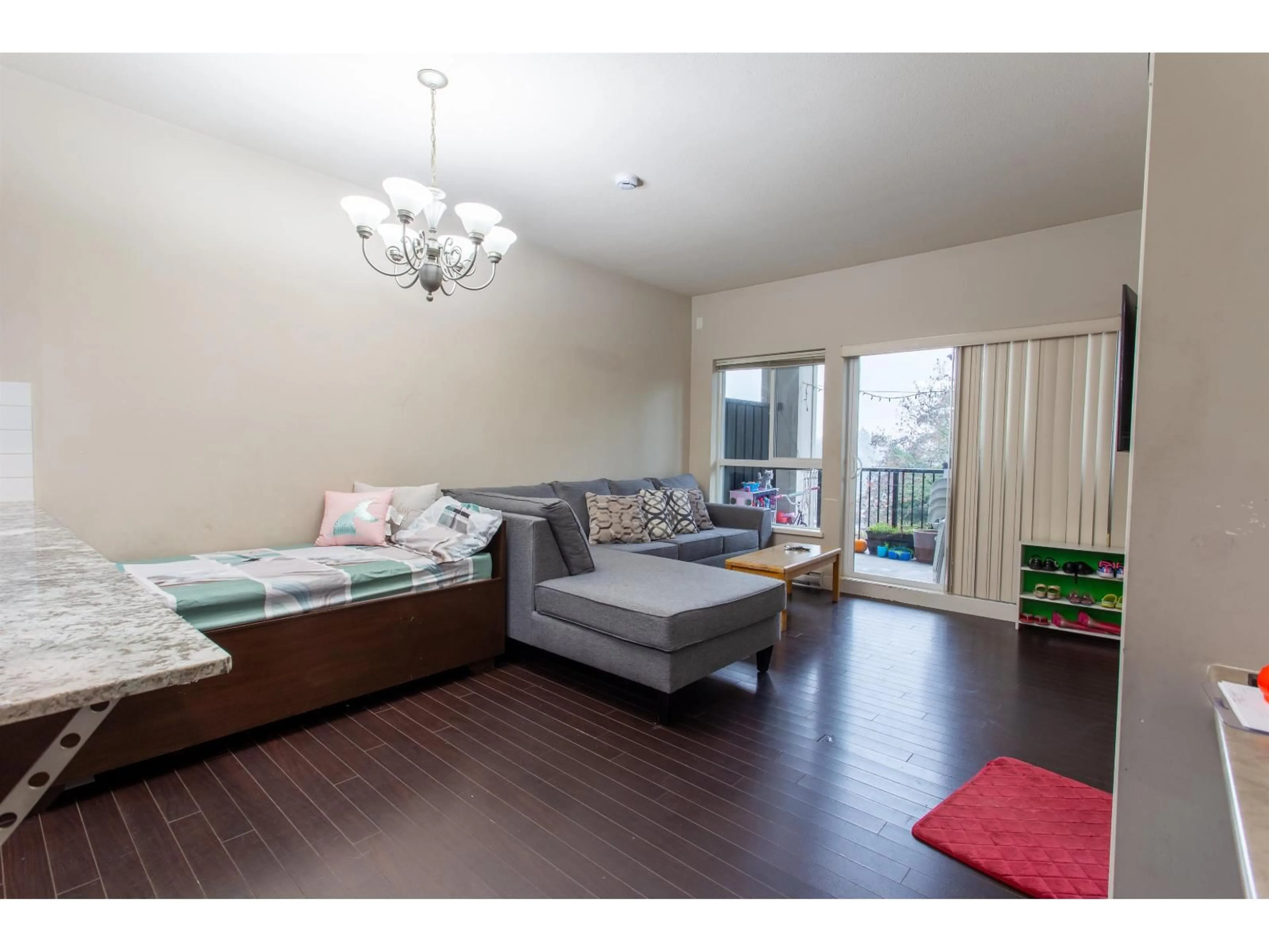 Living room with furniture, wood/laminate floor for 409 - 9655 KING GEORGE BOULEVARD, Surrey British Columbia V3T0C7