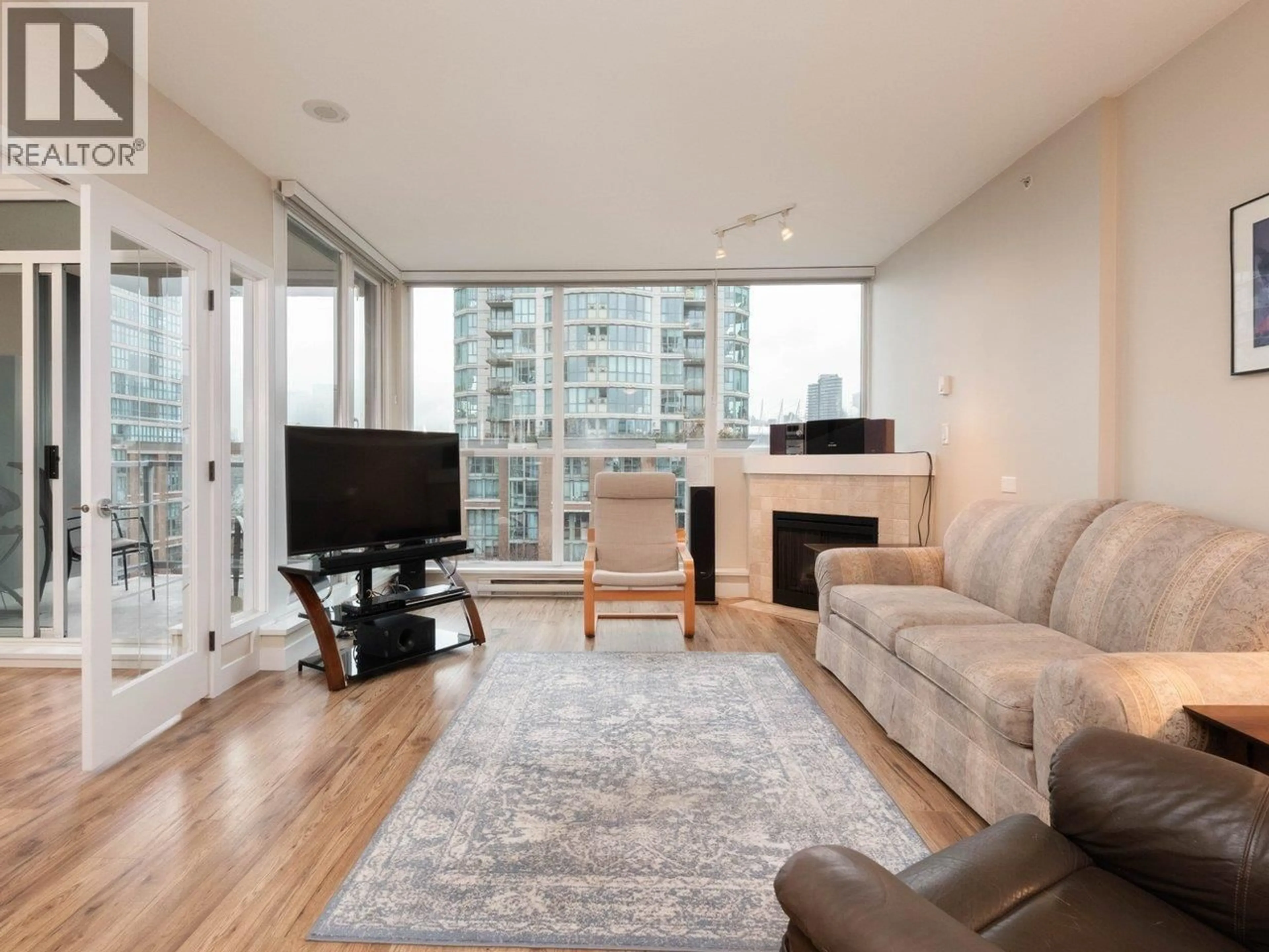 Living room with furniture, wood/laminate floor for 706 - 189 NATIONAL AVENUE, Vancouver British Columbia V6A4L8
