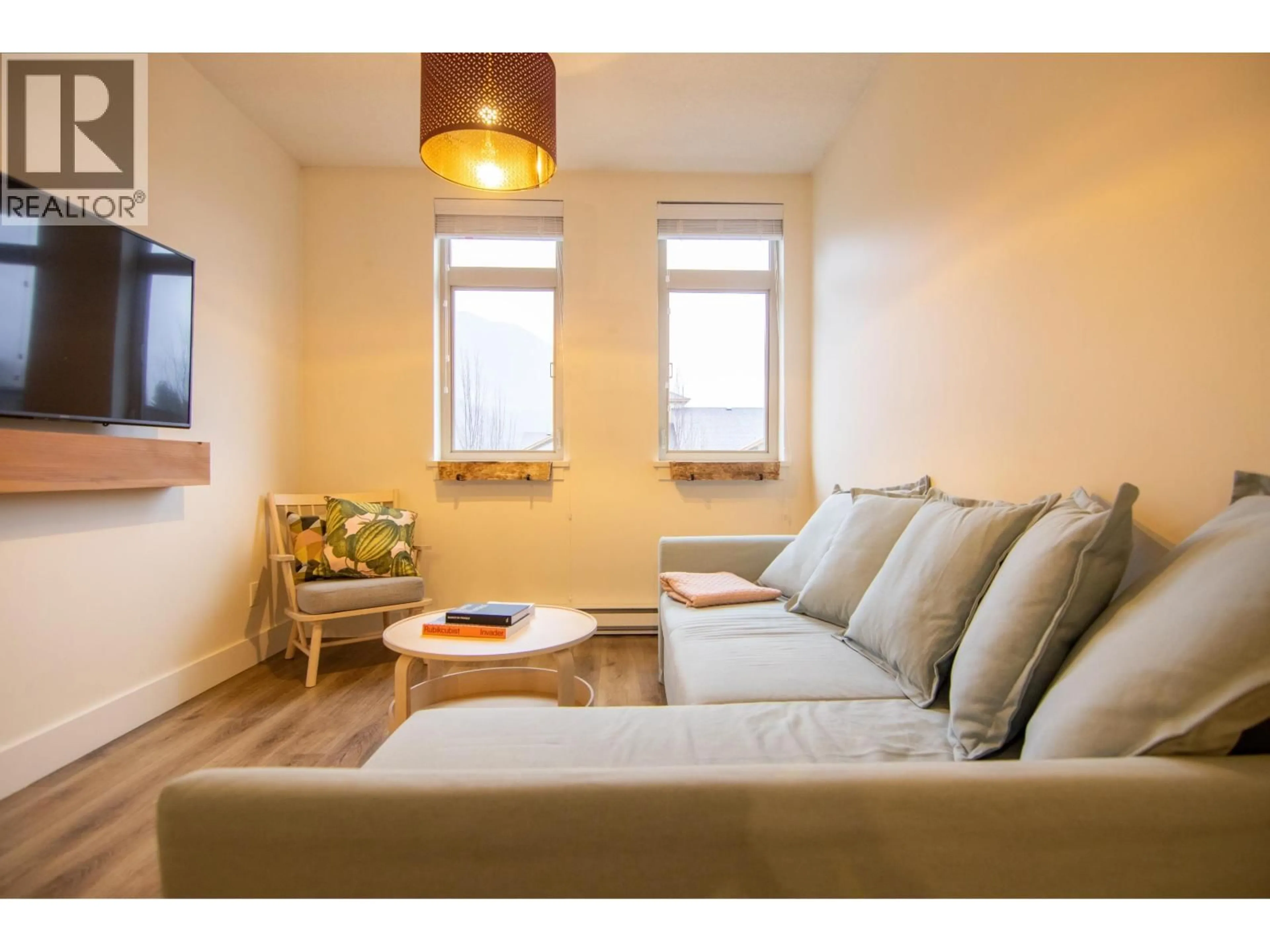 Living room with furniture, wood/laminate floor for 305 - 7330 ARBUTUS STREET, Pemberton British Columbia V0N2L1