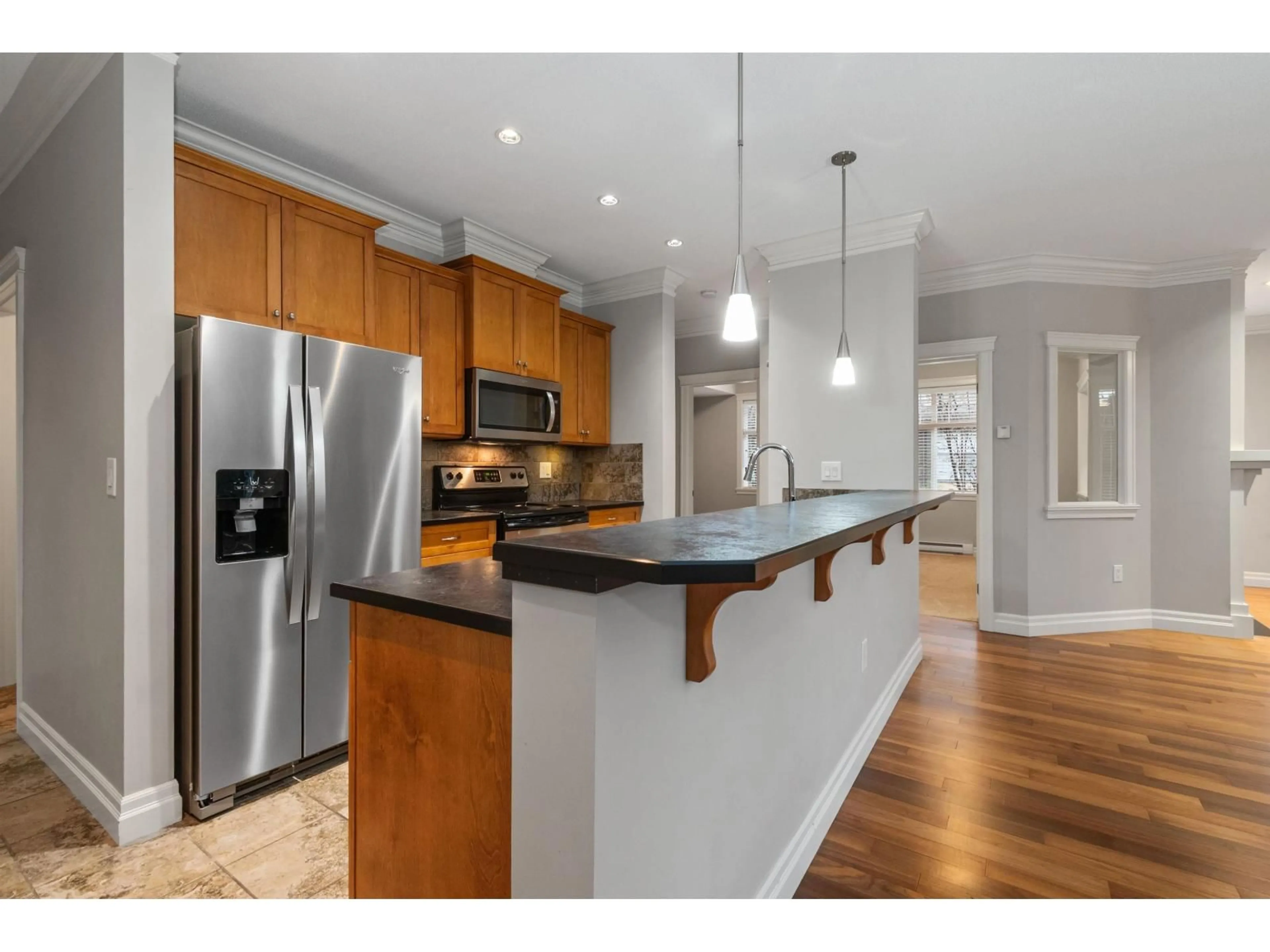 Open concept kitchen, wood/laminate floor for 101C - 45595 TAMIHI WAY, Chilliwack British Columbia V2R0G3