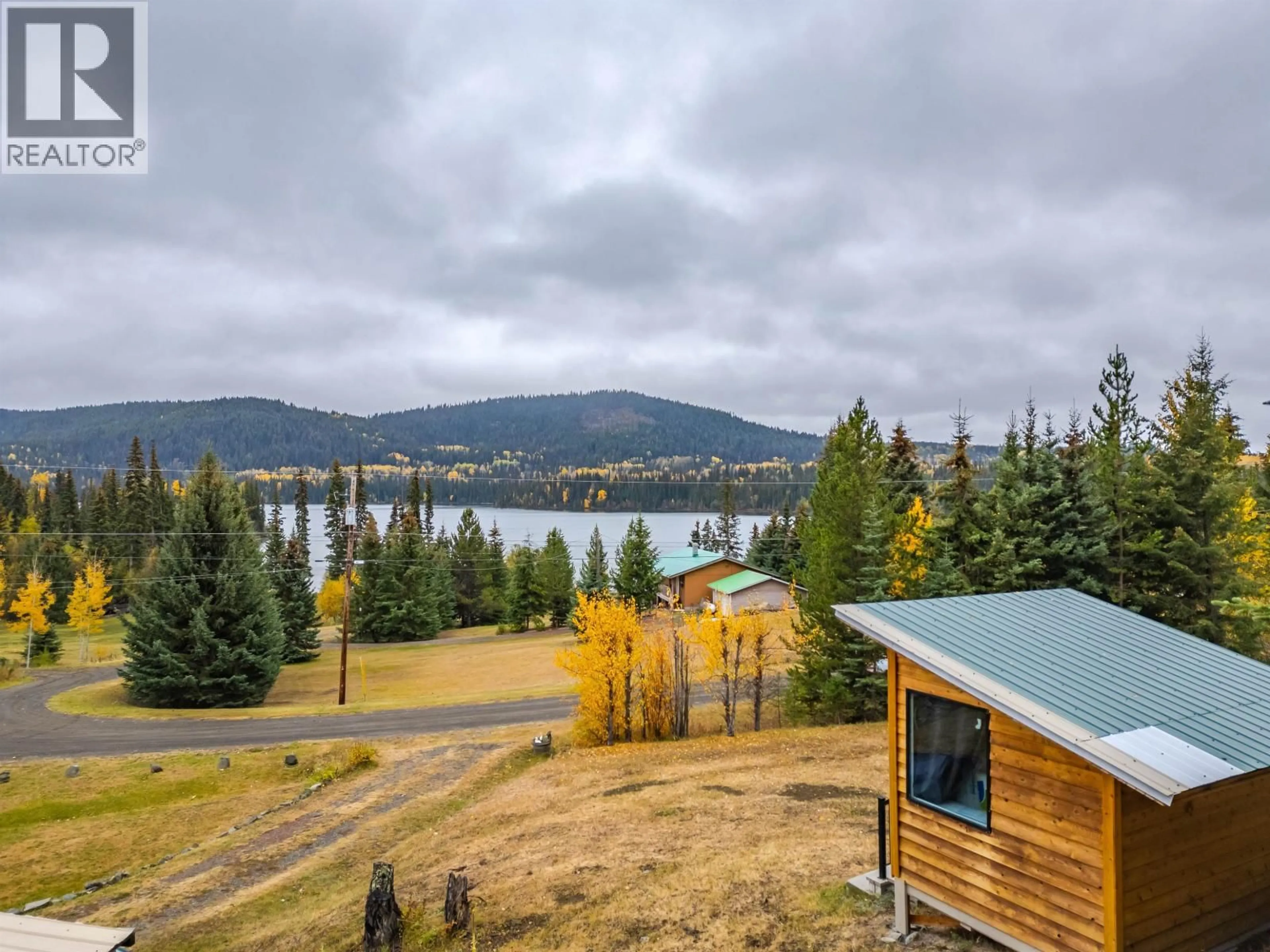 A pic from outside/outdoor area/front of a property/back of a property/a pic from drone, water/lake/river/ocean view for 7561 MCCARTHY ROAD, Bridge Lake British Columbia V0K1X2