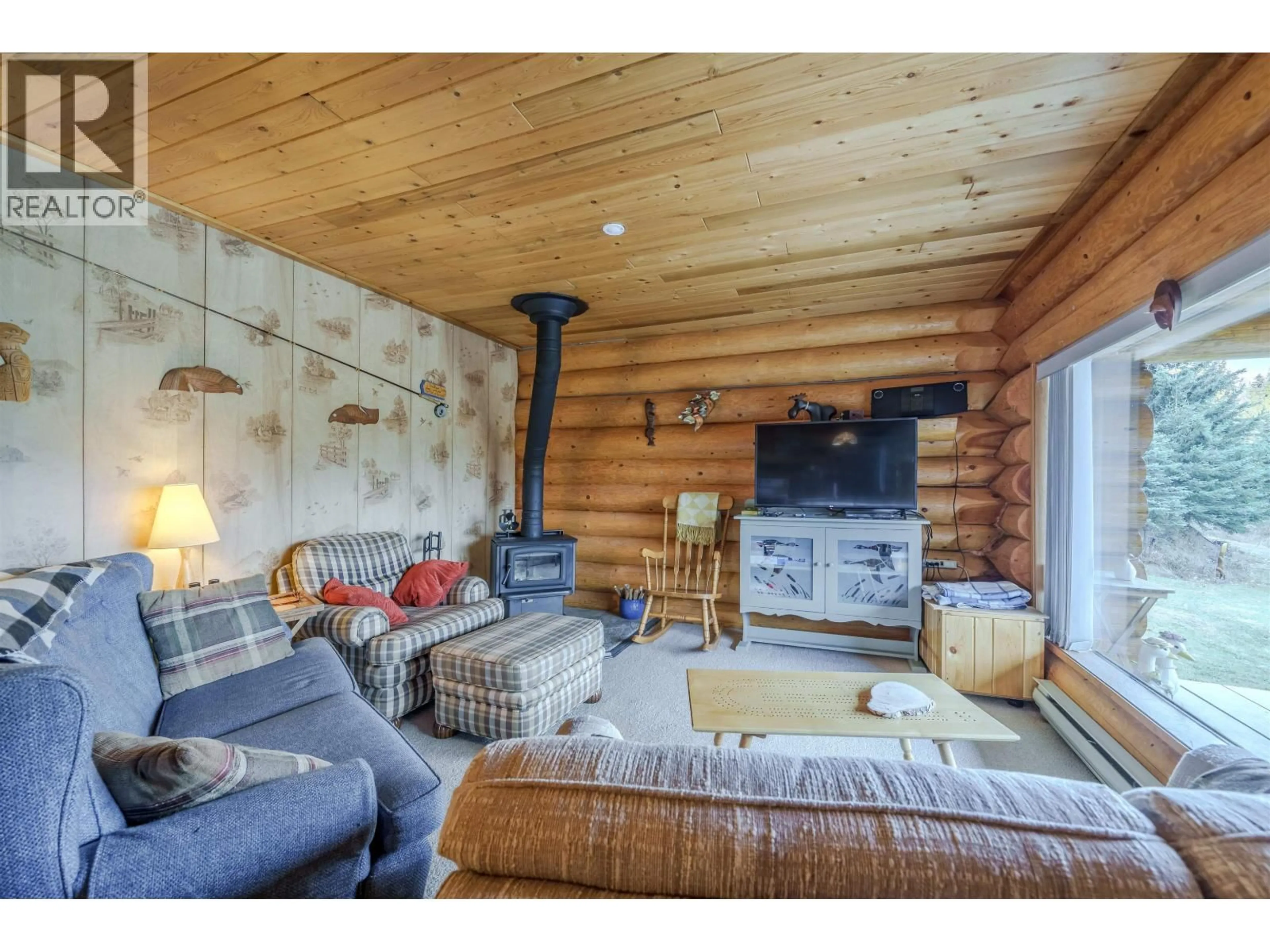 Living room with furniture, wood/laminate floor for 7561 MCCARTHY ROAD, Bridge Lake British Columbia V0K1X2
