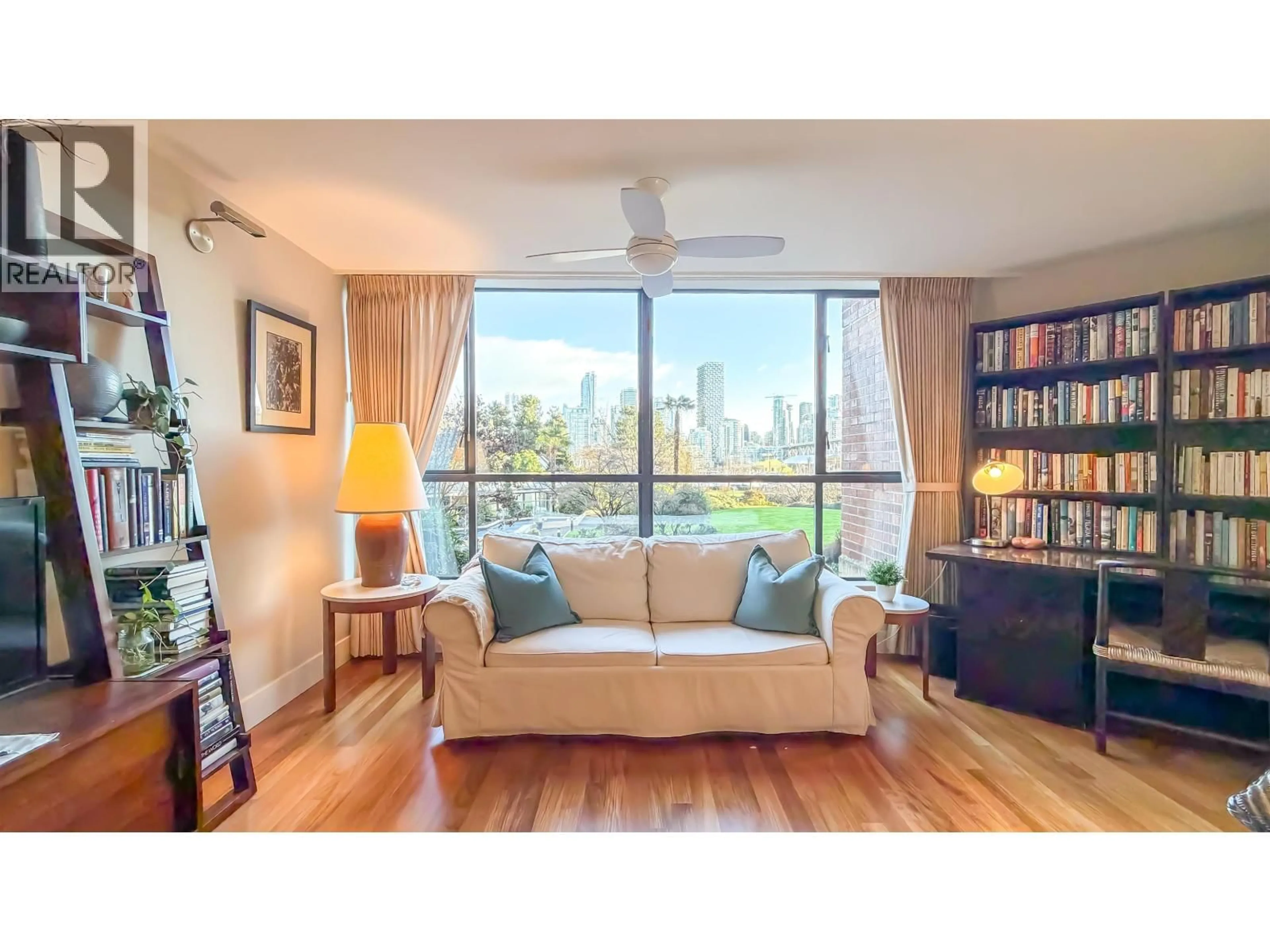 Living room with furniture, wood/laminate floor for 109 - 1490 PENNYFARTHING DRIVE, Vancouver British Columbia V6J4Z3