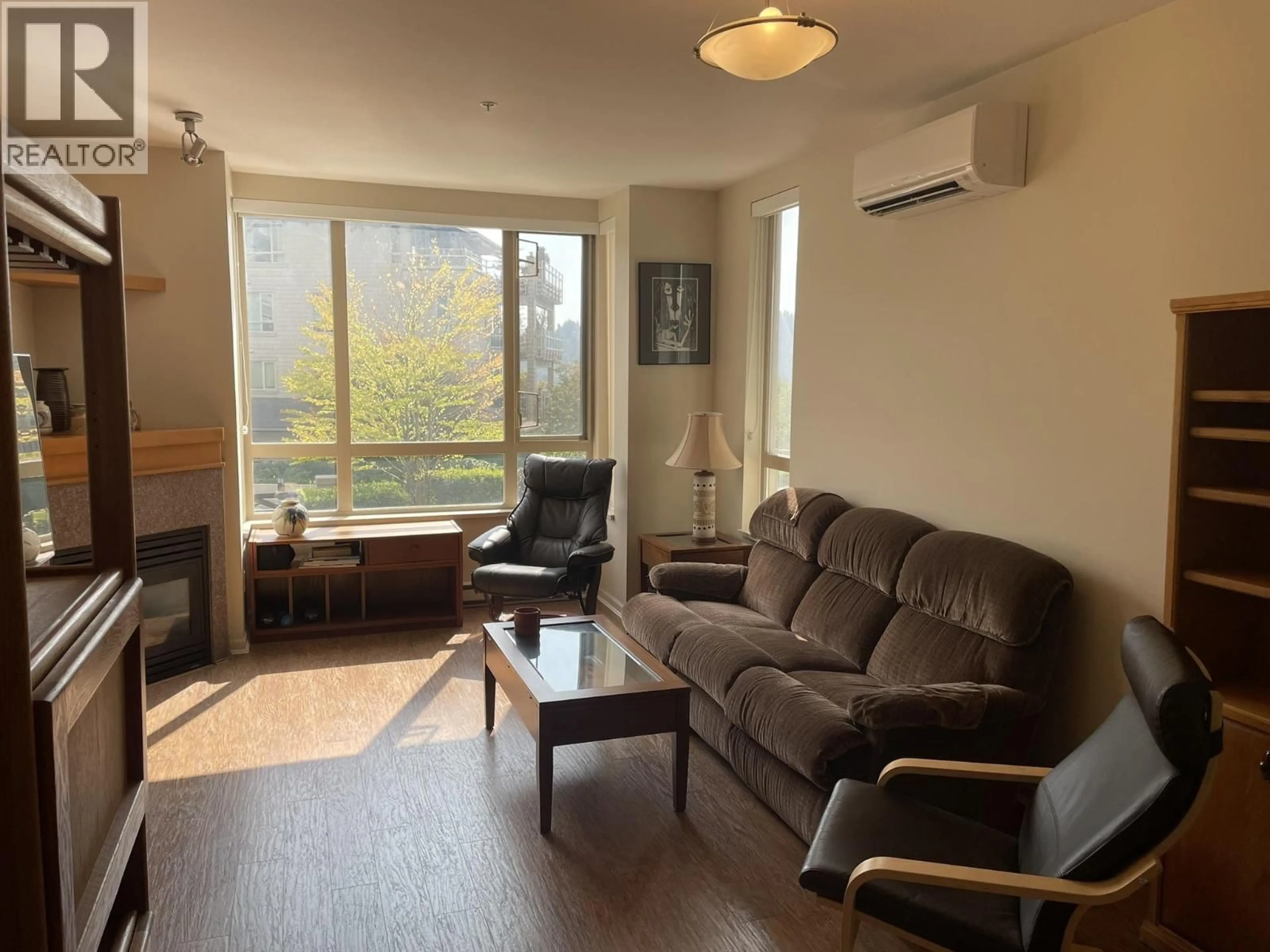 Living room with furniture, wood/laminate floor for 207 - 580 RAVEN WOODS DRIVE, North Vancouver British Columbia V7G2T2