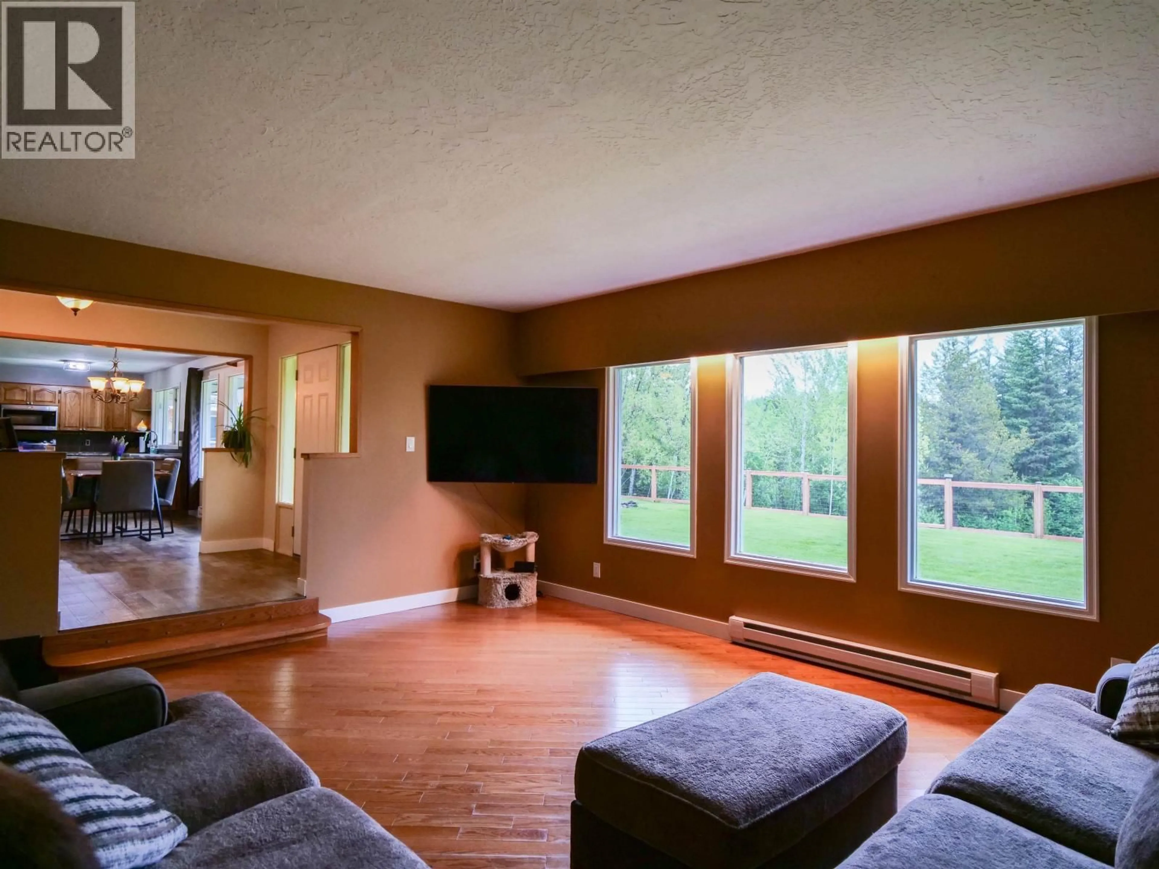 Living room with furniture, wood/laminate floor for 4678 TEN MILE LAKE ROAD, Quesnel British Columbia V2J6X2