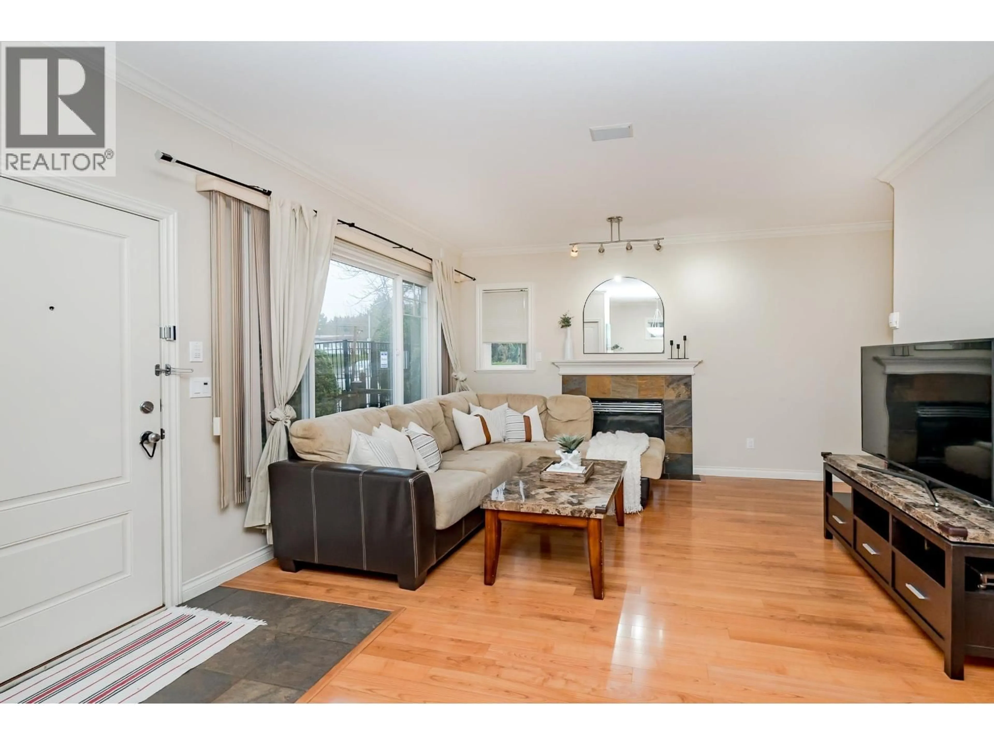 Living room with furniture, wood/laminate floor for 10 - 7060 BRIDGE STREET, Richmond British Columbia V6Y2S7