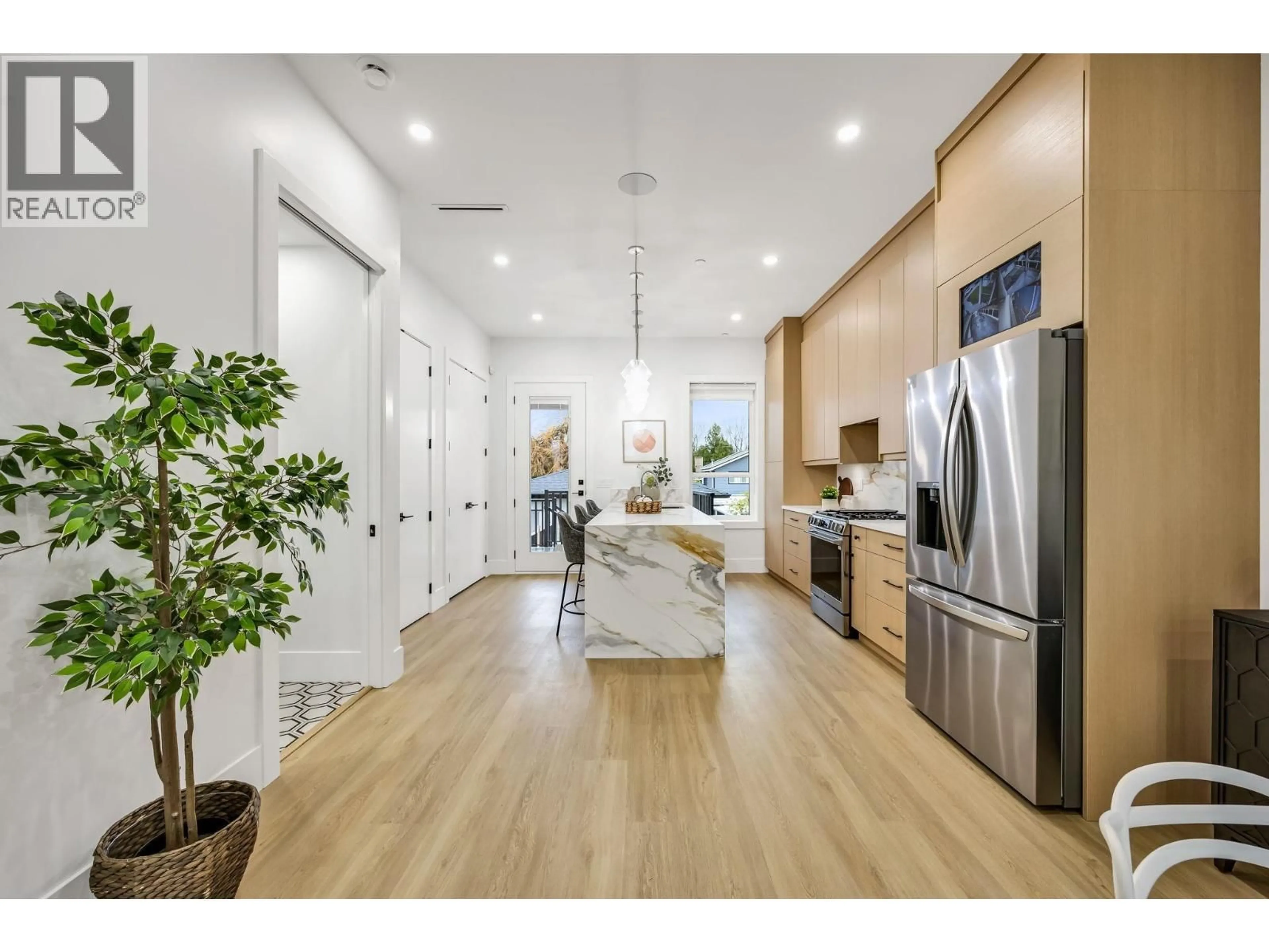 Open concept kitchen, wood/laminate floor for 2827 DUNDAS STREET, Vancouver British Columbia V5K1R5