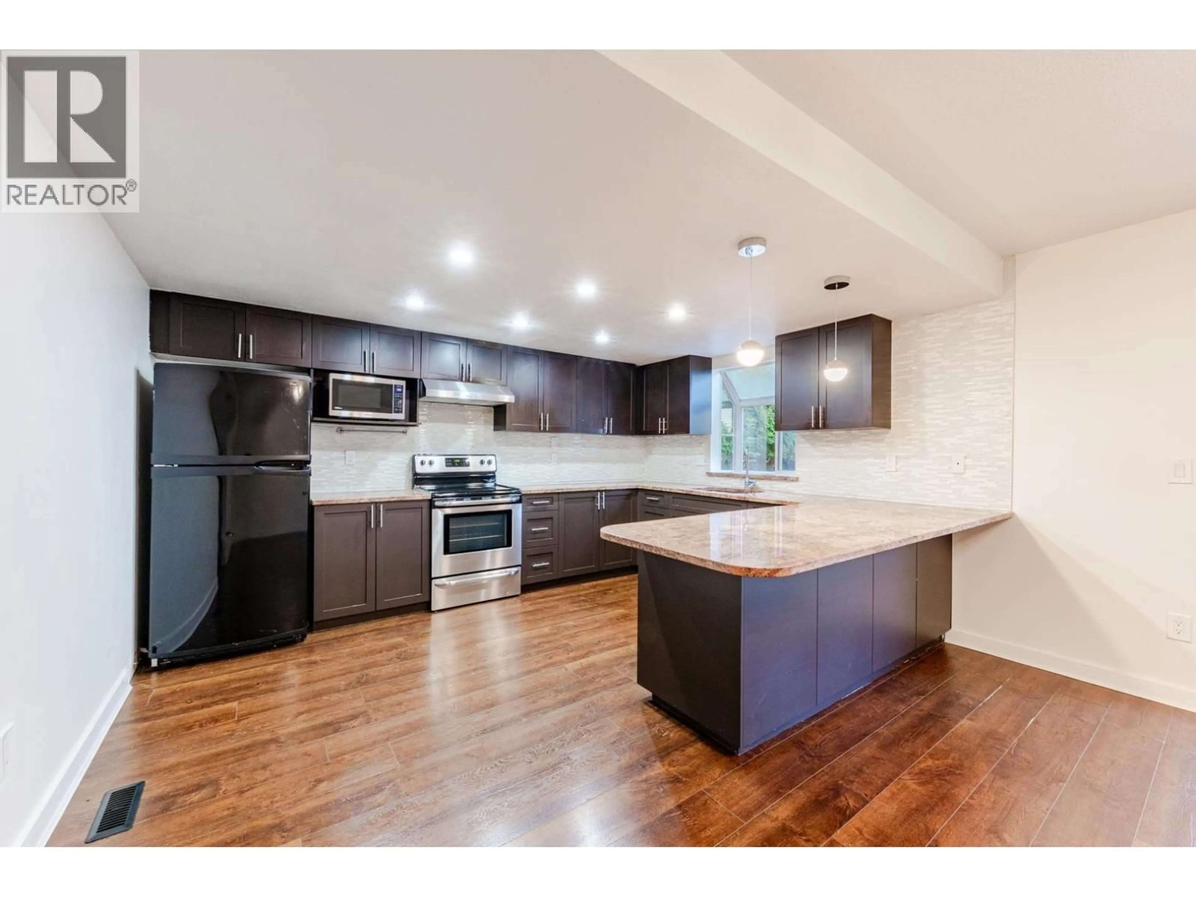 Open concept kitchen, wood/laminate floor for 8008 ASH STREET, Richmond British Columbia V6Y3H8