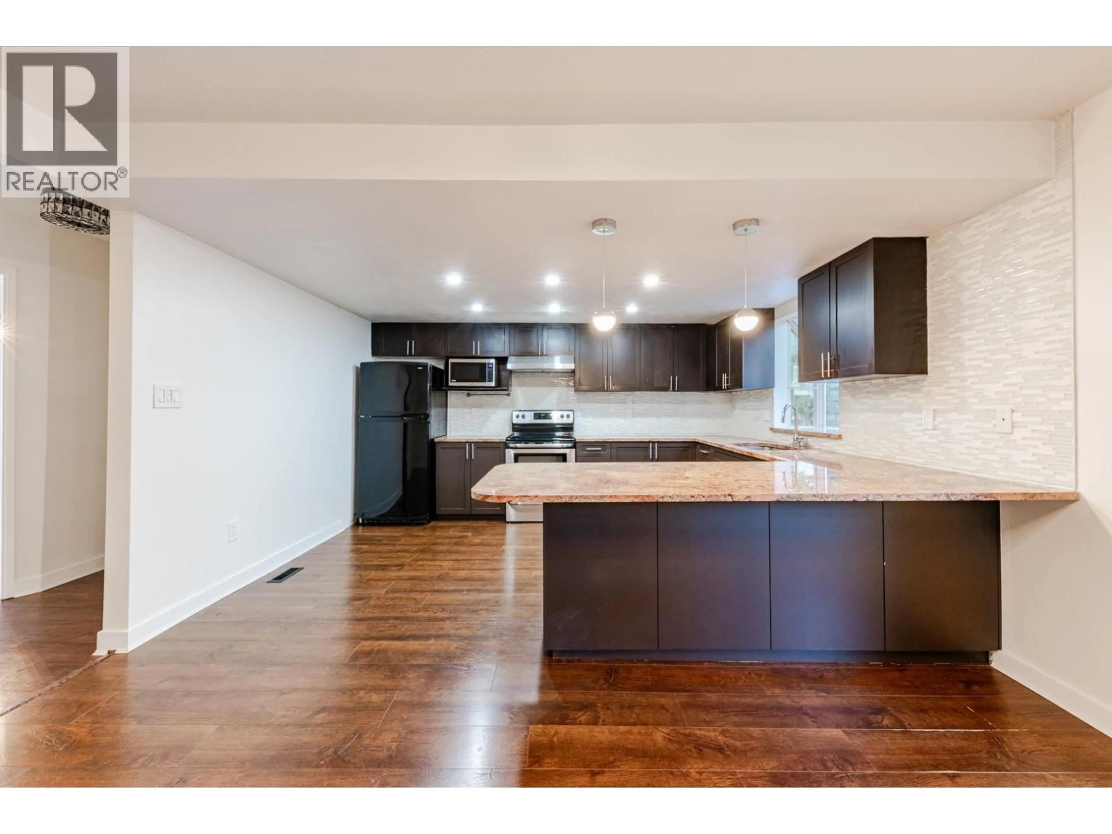 Open concept kitchen, wood/laminate floor for 8008 ASH STREET, Richmond British Columbia V6Y3H8