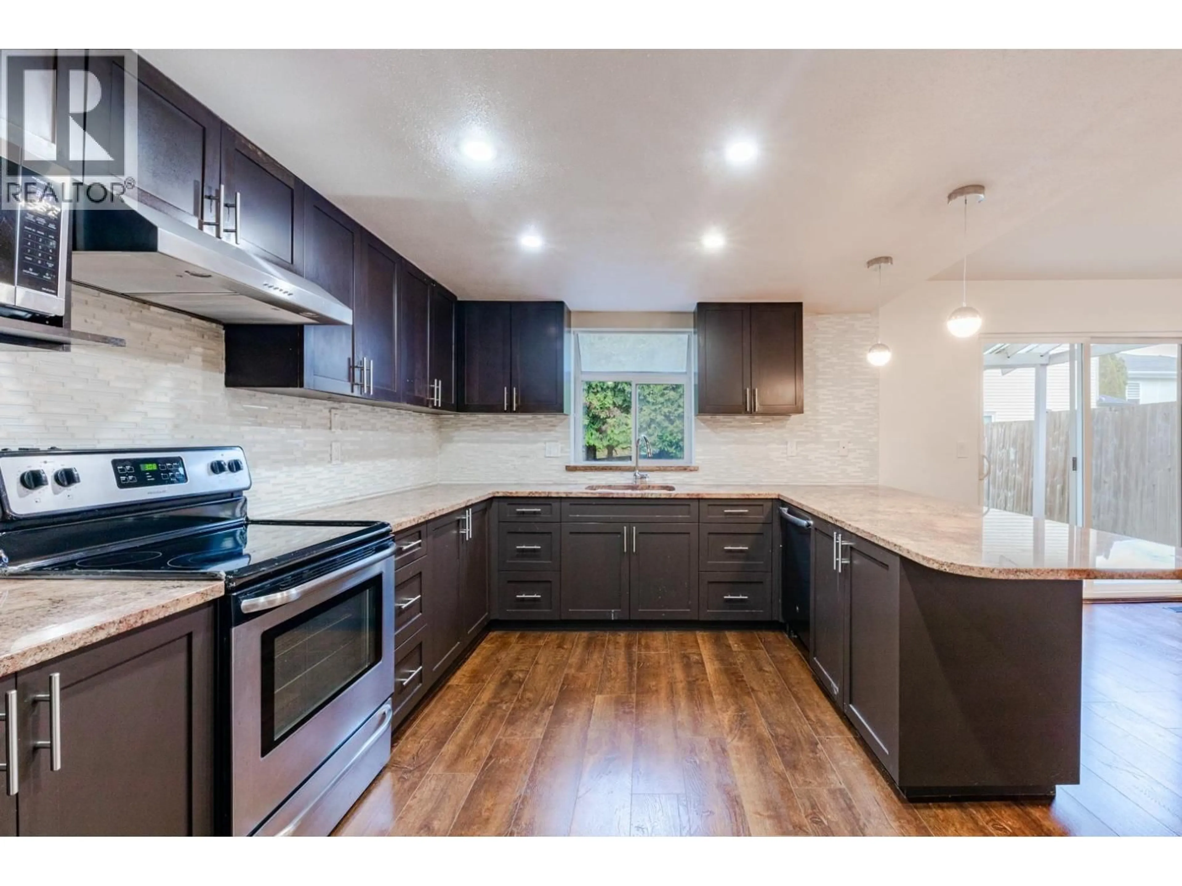 Open concept kitchen, wood/laminate floor for 8008 ASH STREET, Richmond British Columbia V6Y3H8
