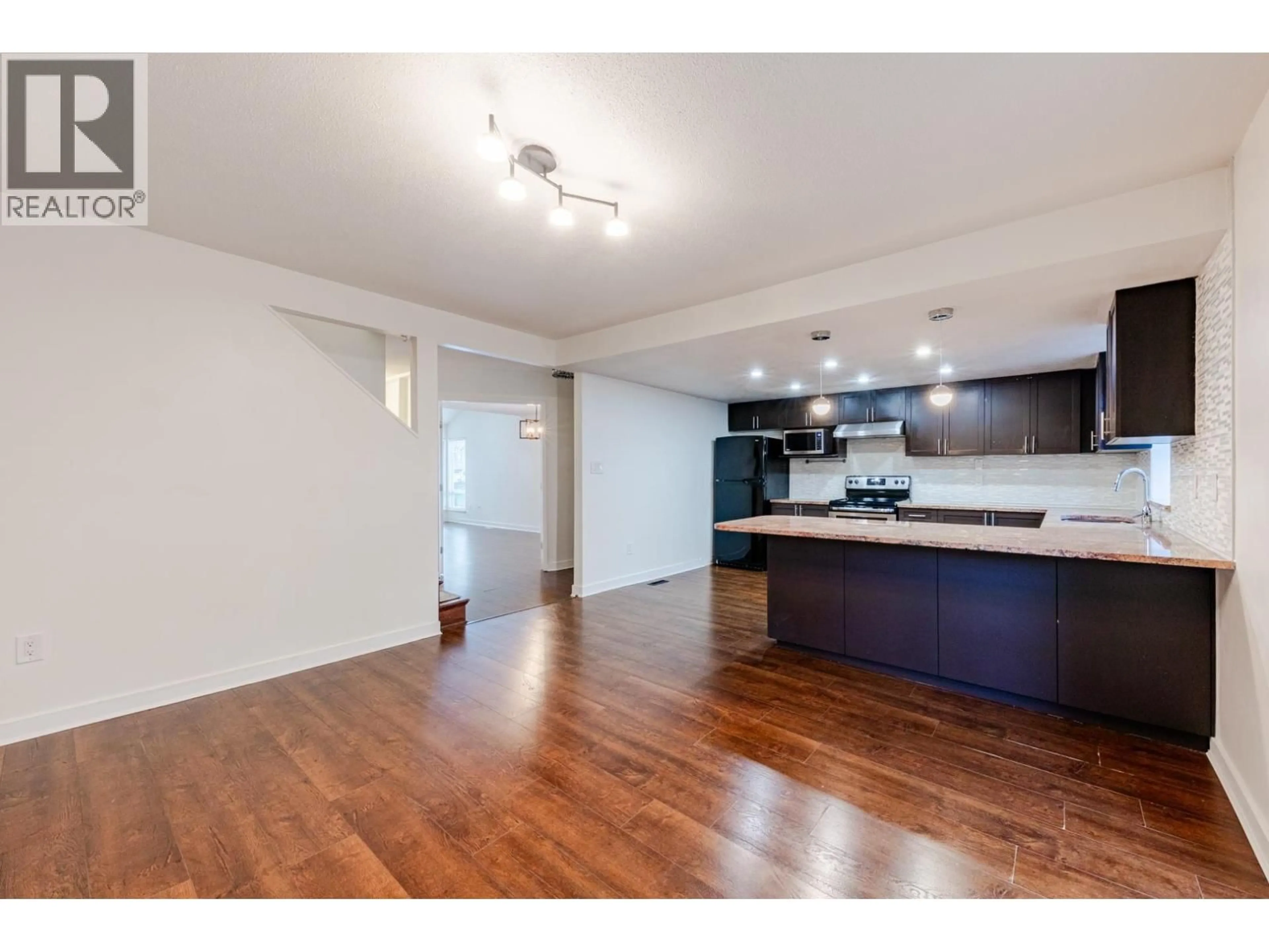 Open concept kitchen, wood/laminate floor for 8008 ASH STREET, Richmond British Columbia V6Y3H8