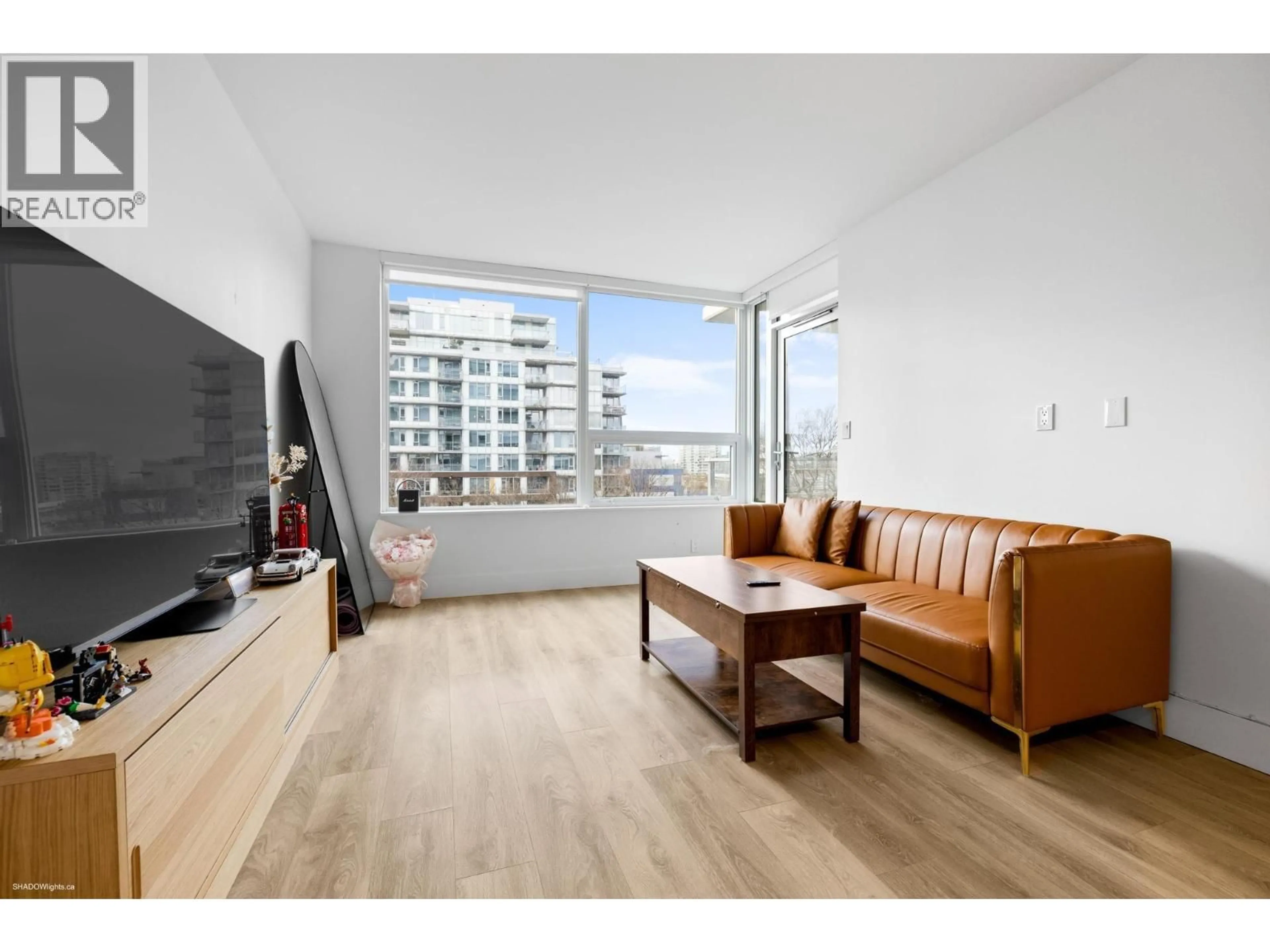 Living room with furniture, wood/laminate floor for 606 - 5508 HOLLYBRIDGE WAY, Richmond British Columbia V7C0C7