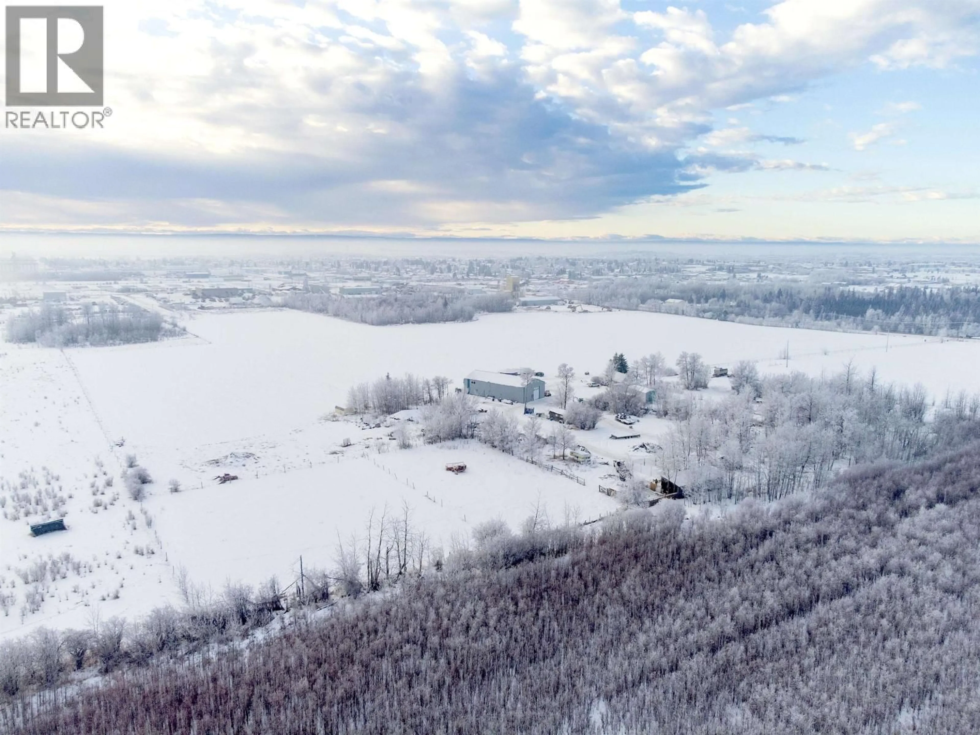 A pic from outside/outdoor area/front of a property/back of a property/a pic from drone, mountain view for 10727 NORTHERN LIGHTS DRIVE, Fort St. John British Columbia V1J0S8