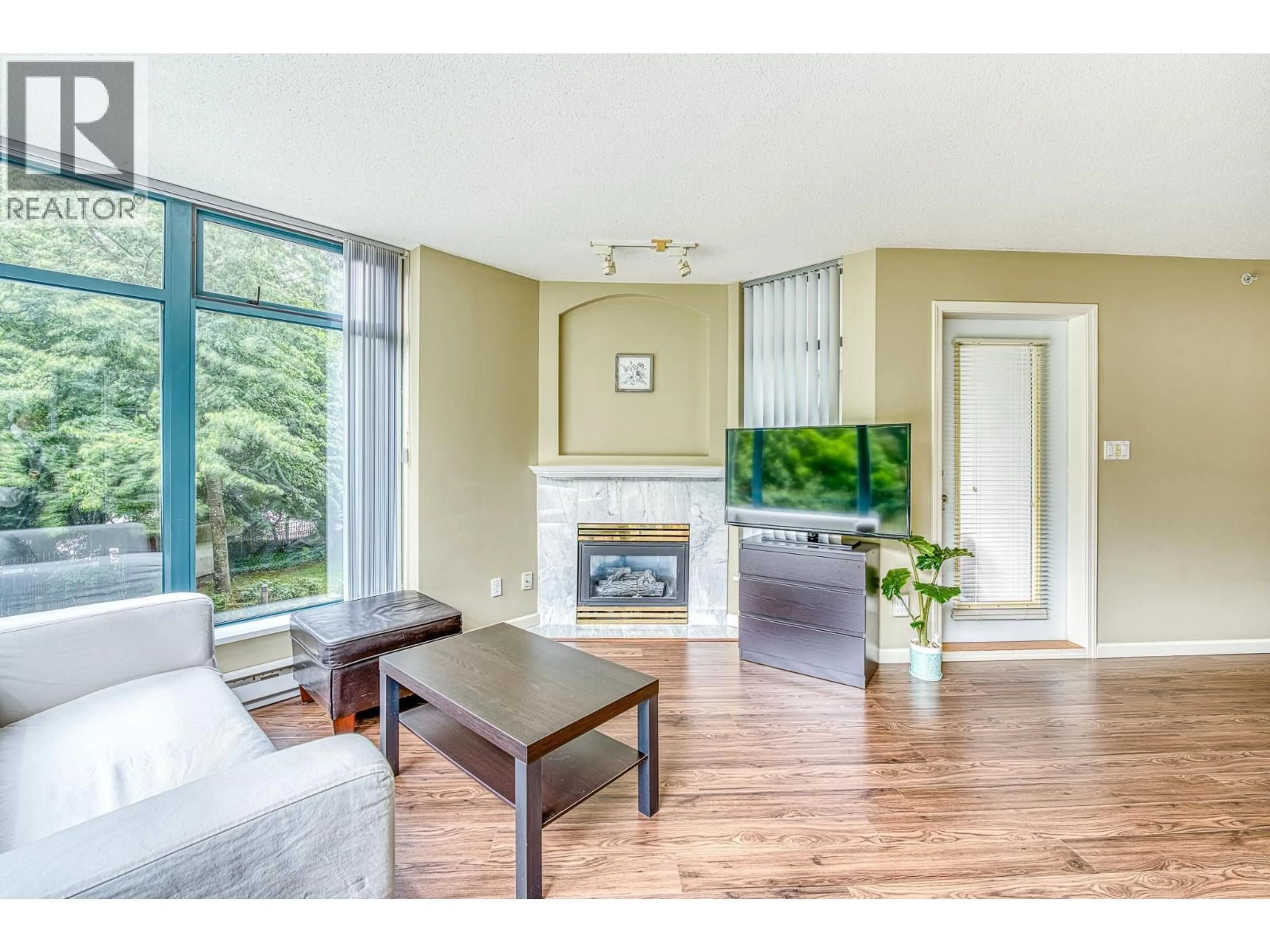 Living room with furniture, wood/laminate floor for 206 - 4505 HAZEL STREET, Burnaby British Columbia V5H4T1