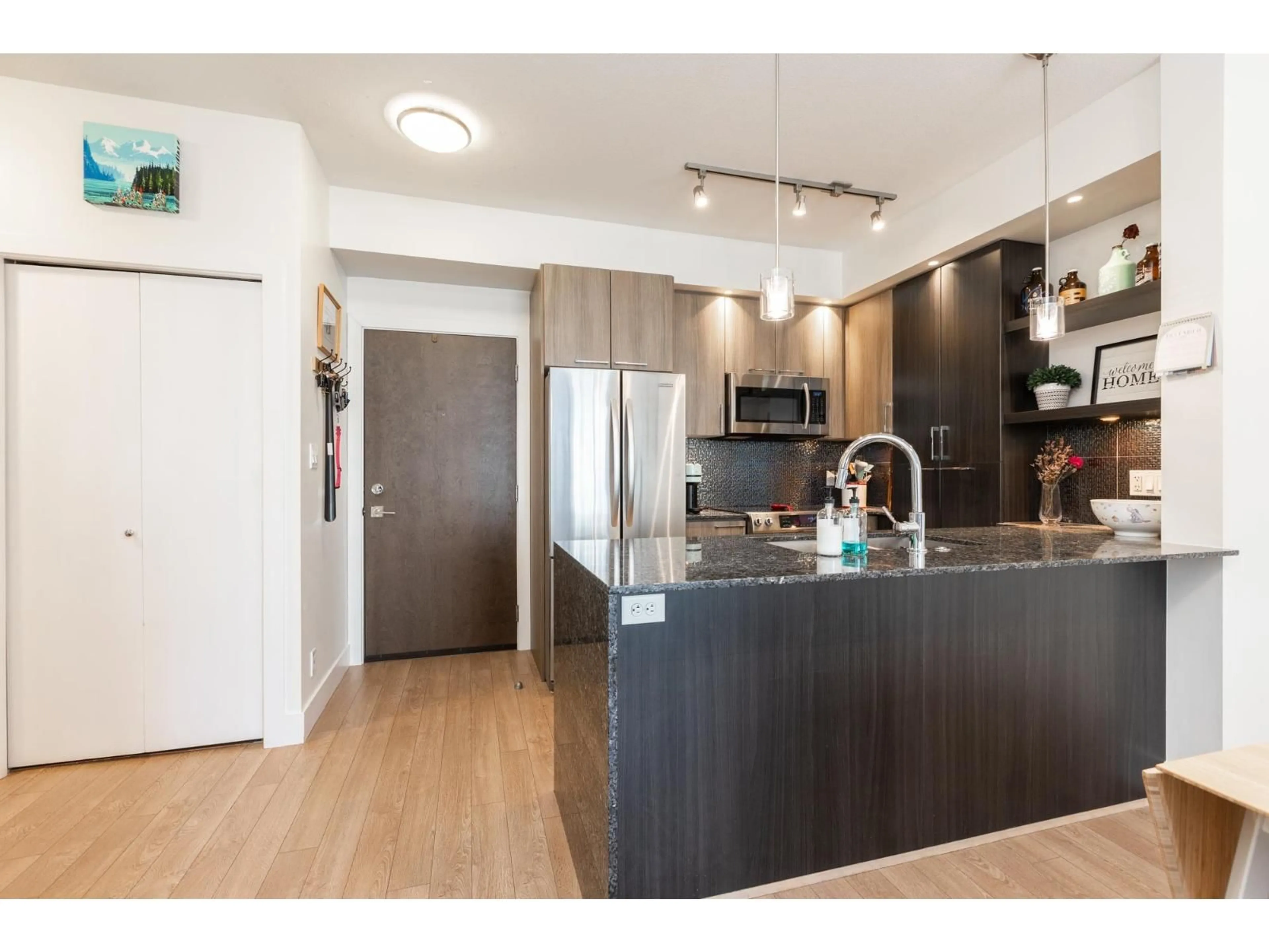 Open concept kitchen, wood/laminate floor for B208 - 20211 66TH AVENUE, Langley British Columbia V2Y0L4