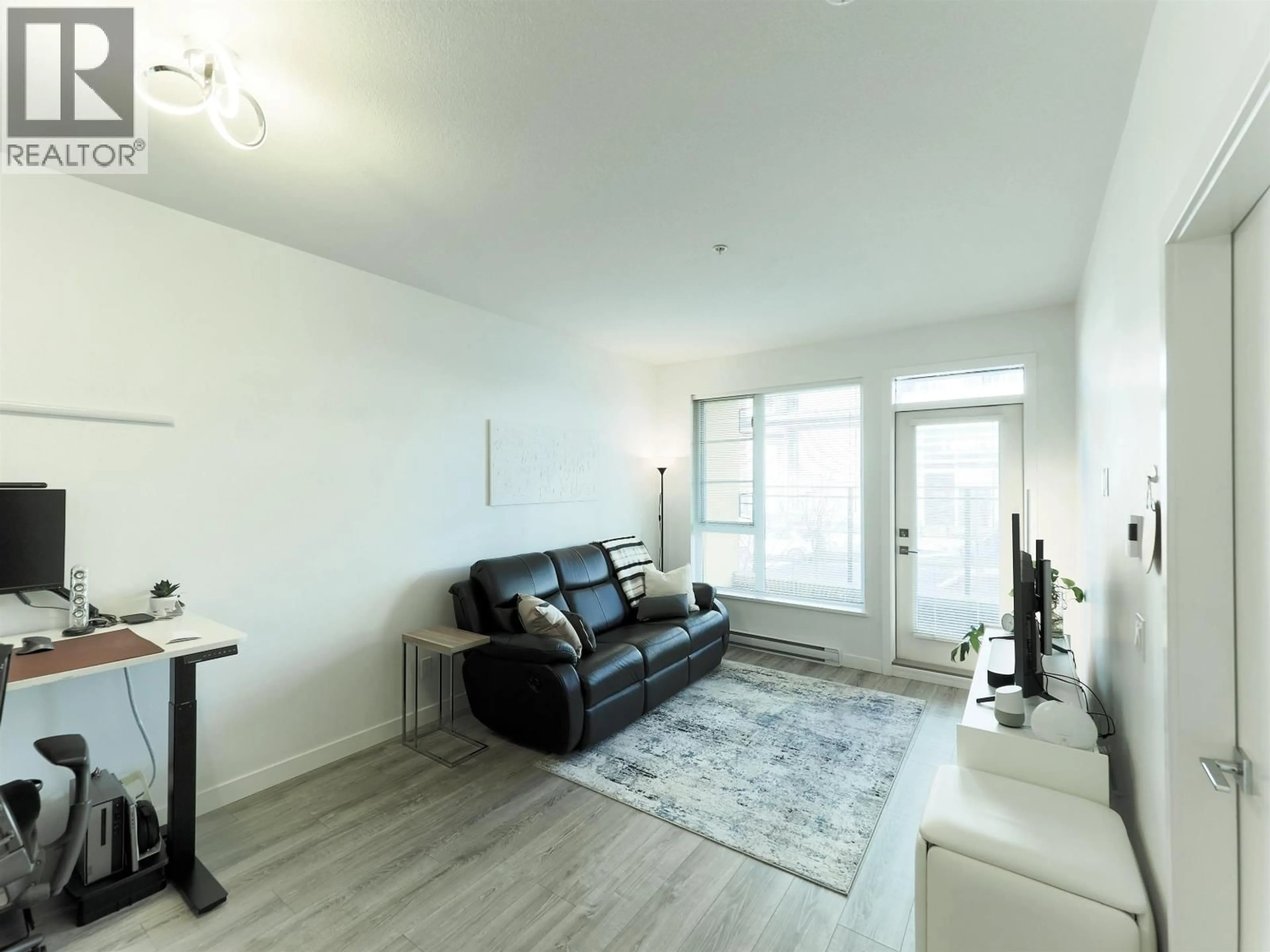 Living room with furniture, wood/laminate floor for 213 - 516 FOSTER AVENUE, Coquitlam British Columbia V3J0H8