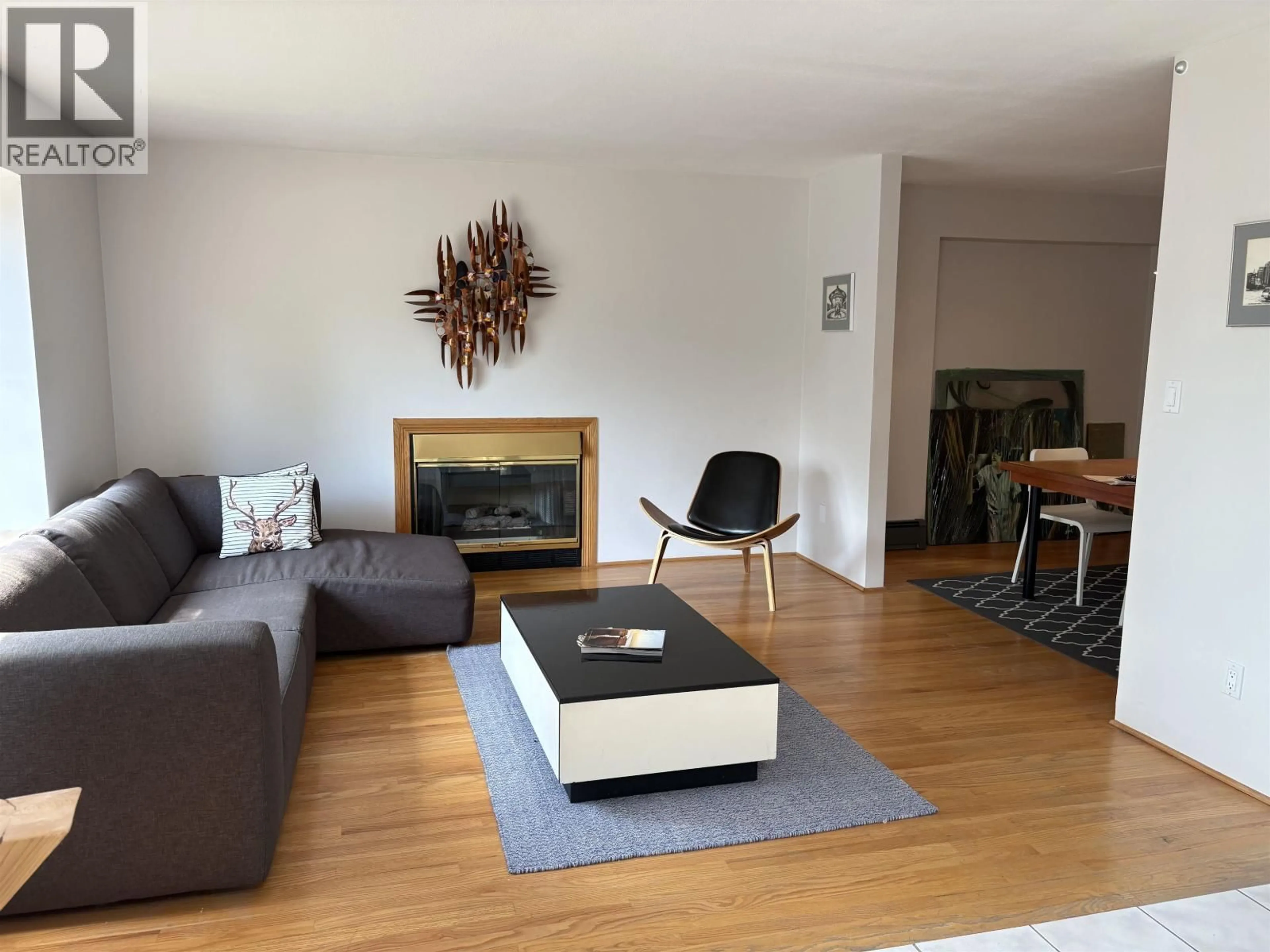 Living room with furniture, wood/laminate floor for 4227 14TH AVENUE, Vancouver British Columbia V6R2X7