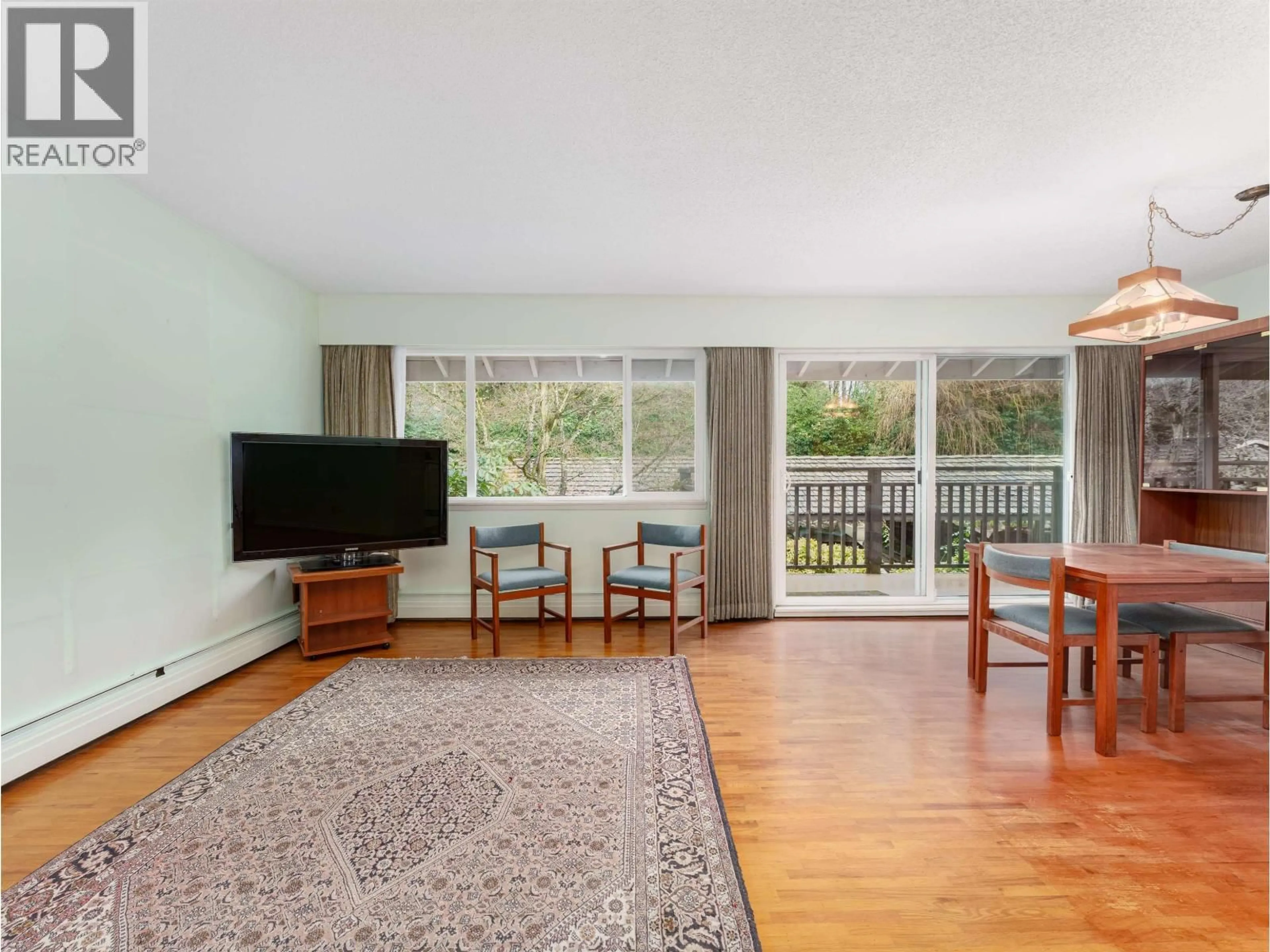 Living room with furniture, wood/laminate floor for 308 - 555 28TH STREET, North Vancouver British Columbia V7N2J7