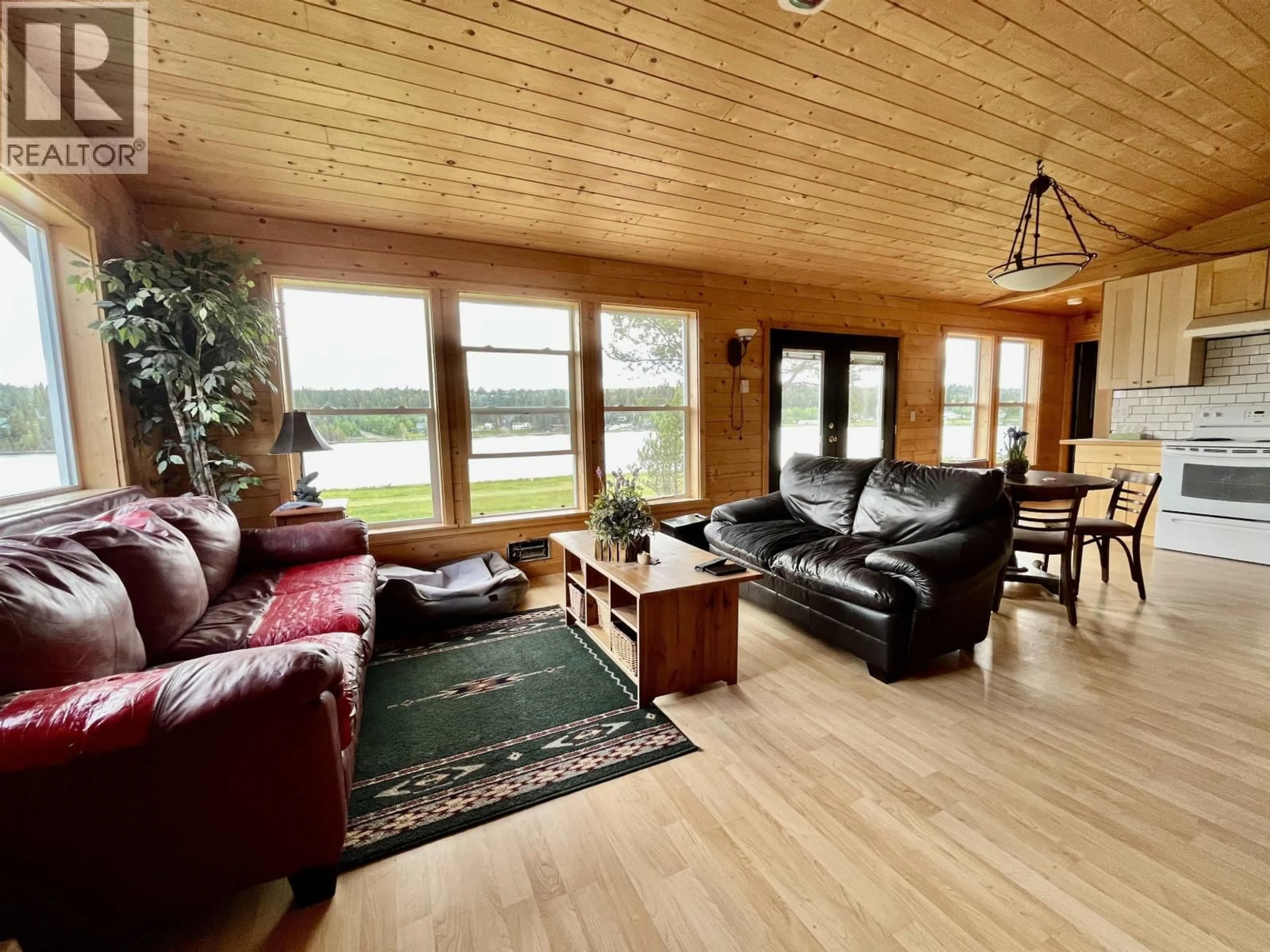 Living room with furniture, wood/laminate floor for 5574 LAKESIDE COURT, 100 Mile House British Columbia V0K2E1