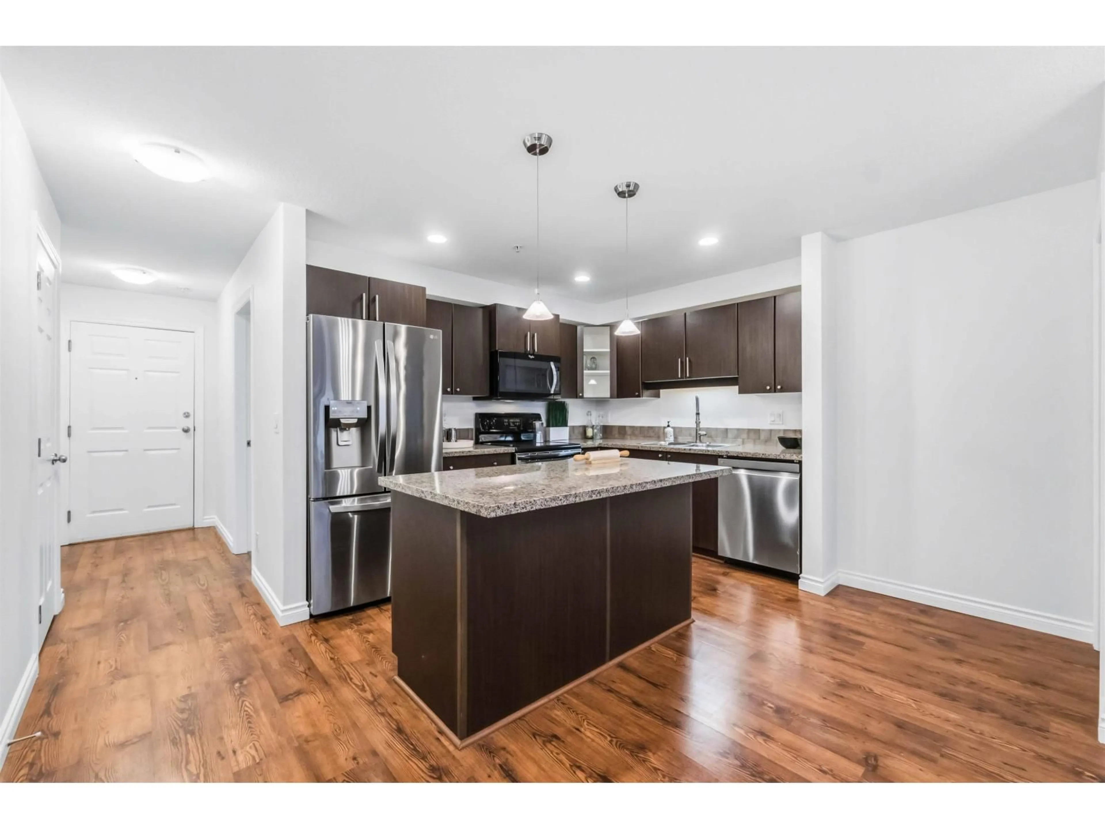 Open concept kitchen, wood/laminate floor for 301 - 5488 198 STREET, Langley British Columbia V3A1G2