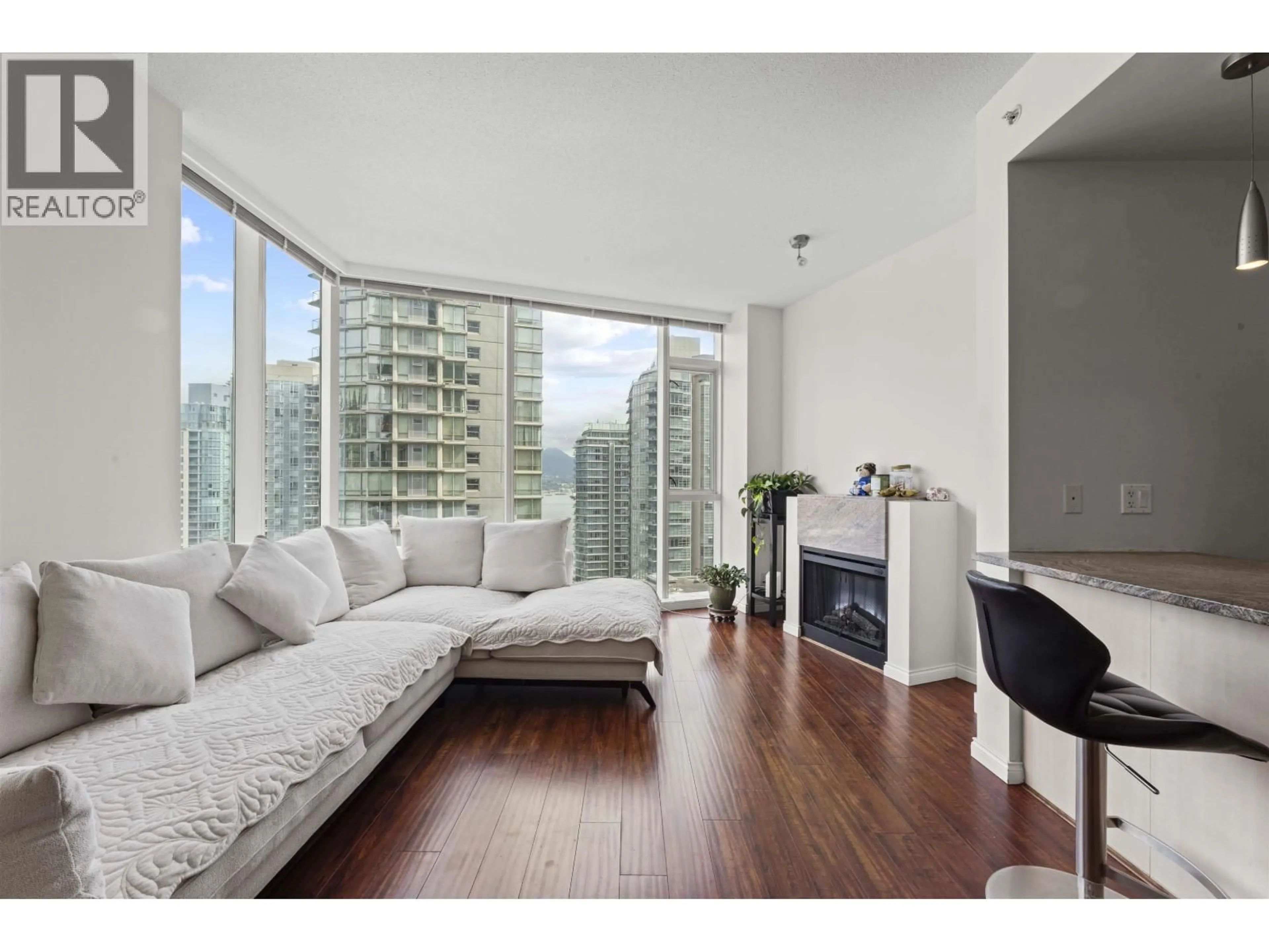 Living room with furniture, wood/laminate floor for 1705 - 1211 MELVILLE STREET, Vancouver British Columbia V6E0A7