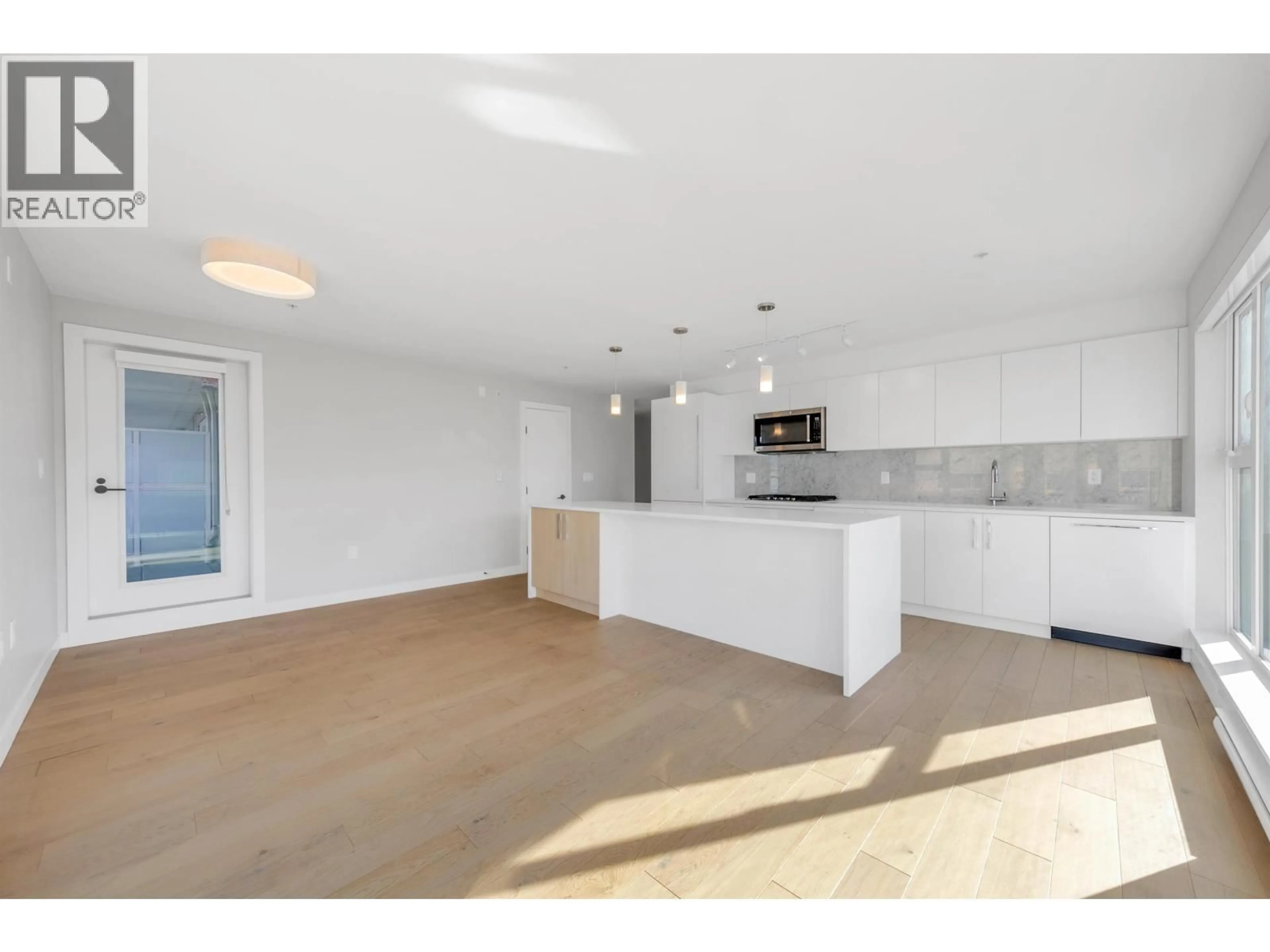Open concept kitchen, unknown for 202 - 2508 FRASER STREET, Vancouver British Columbia V5T3V4