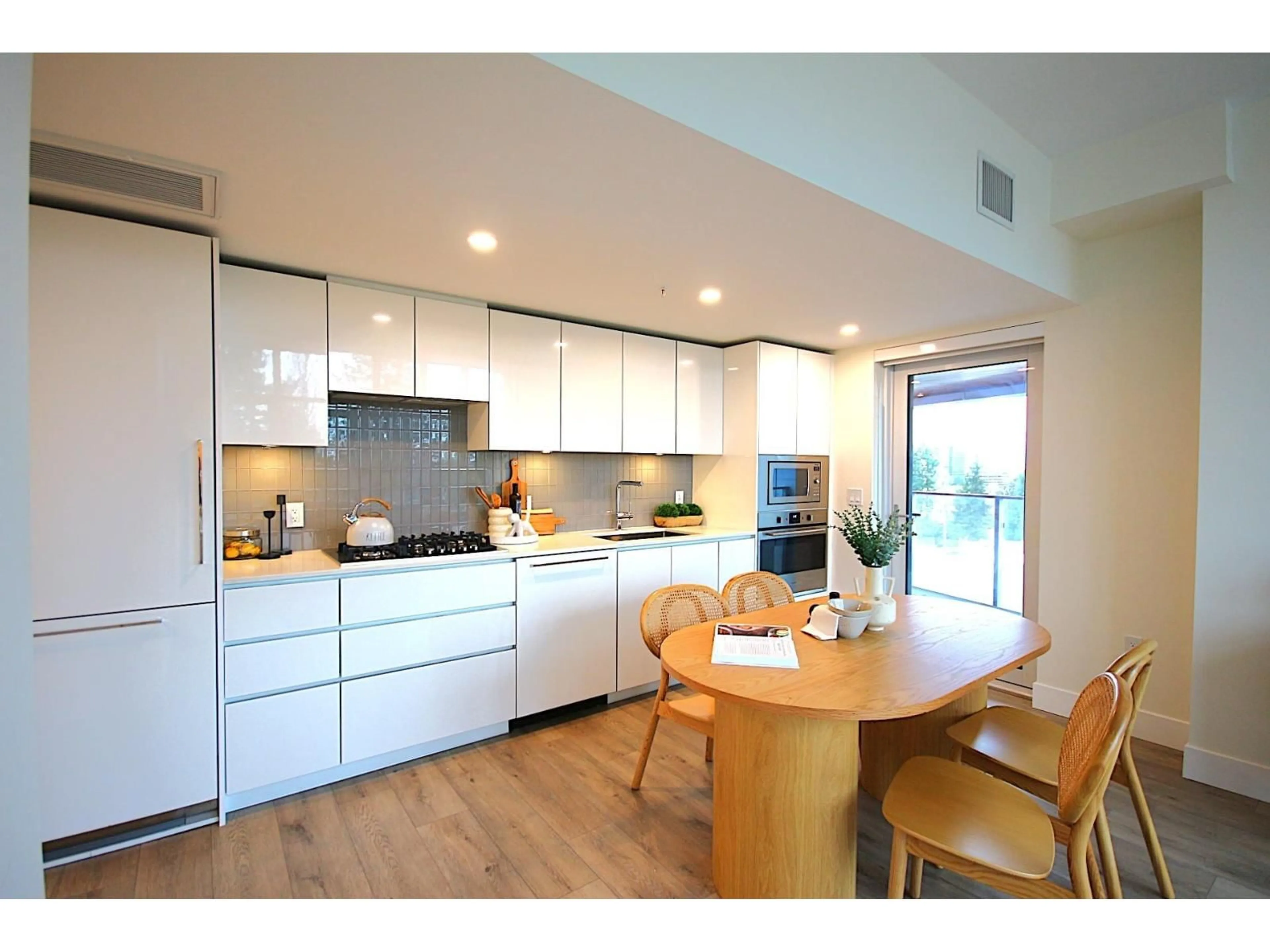 Contemporary kitchen, wood/laminate floor for 610 - 10428 WHALLEY BOULEVARD, Surrey British Columbia V3T0W2