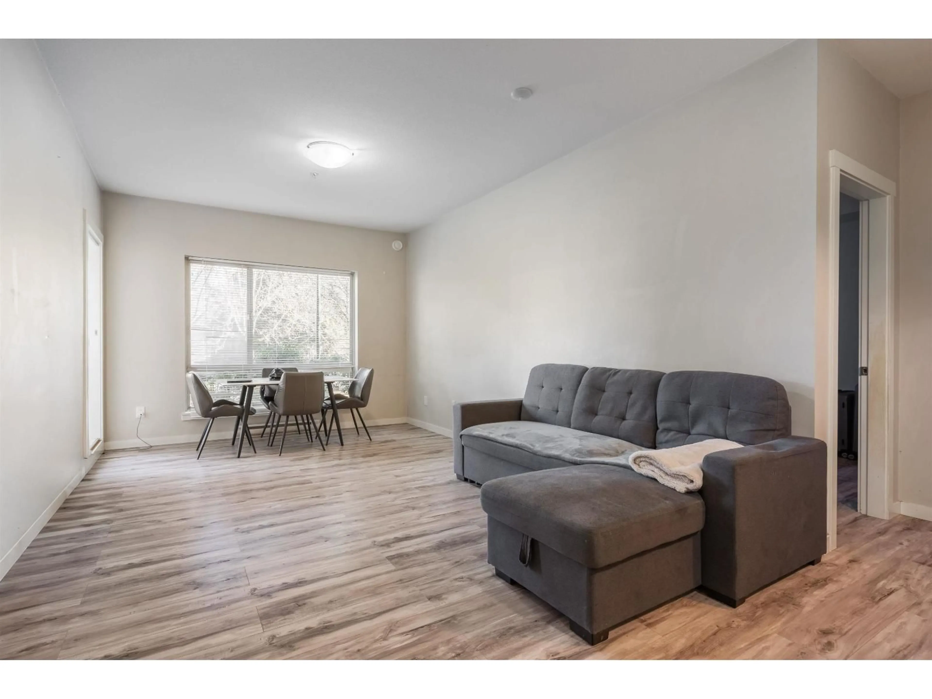 Living room with furniture, wood/laminate floor for 220 - 13789 107A AVENUE, Surrey British Columbia V3T0B8