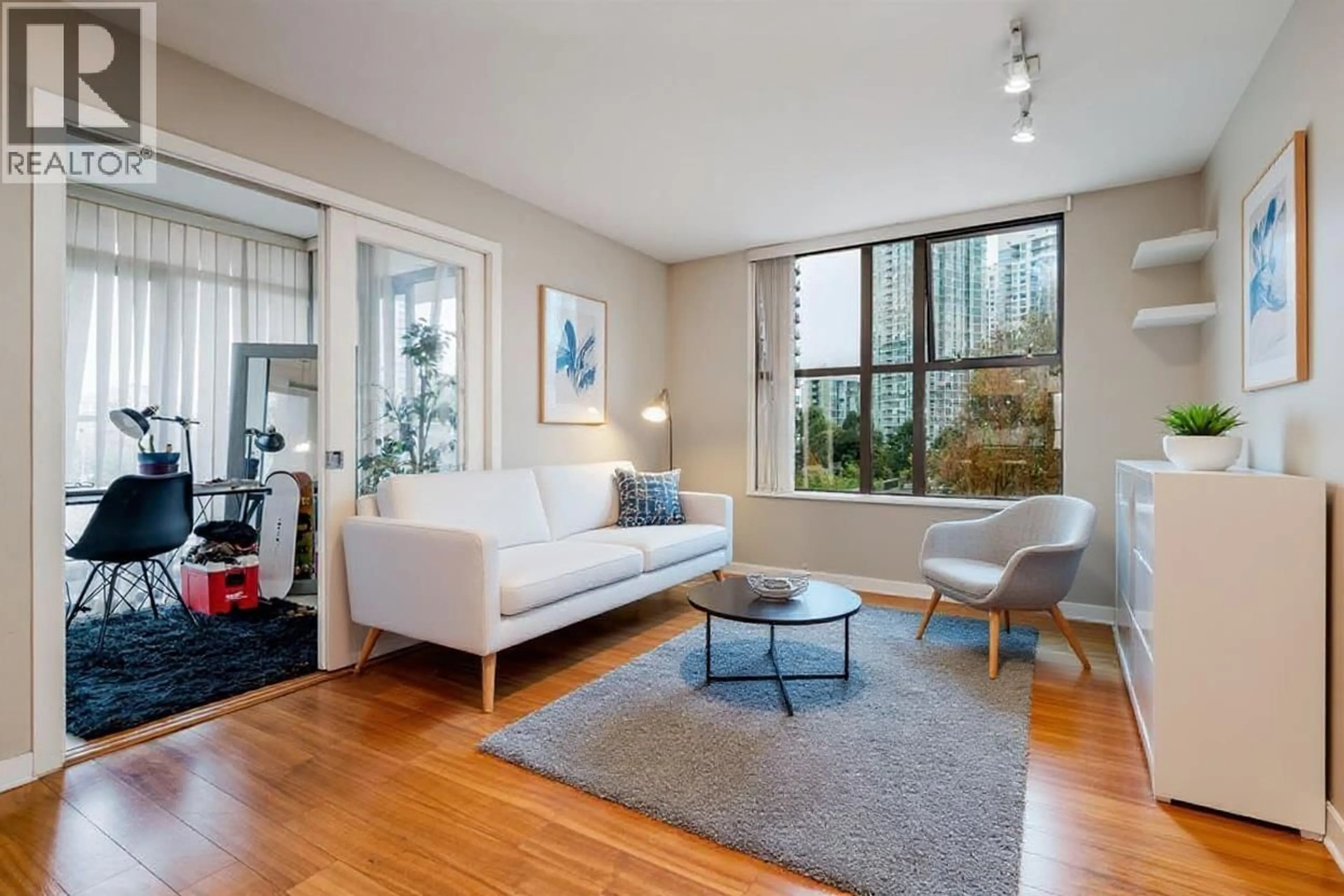 Living room with furniture, wood/laminate floor for 506 - 989 BEATTY STREET, Vancouver British Columbia V6Z3C2