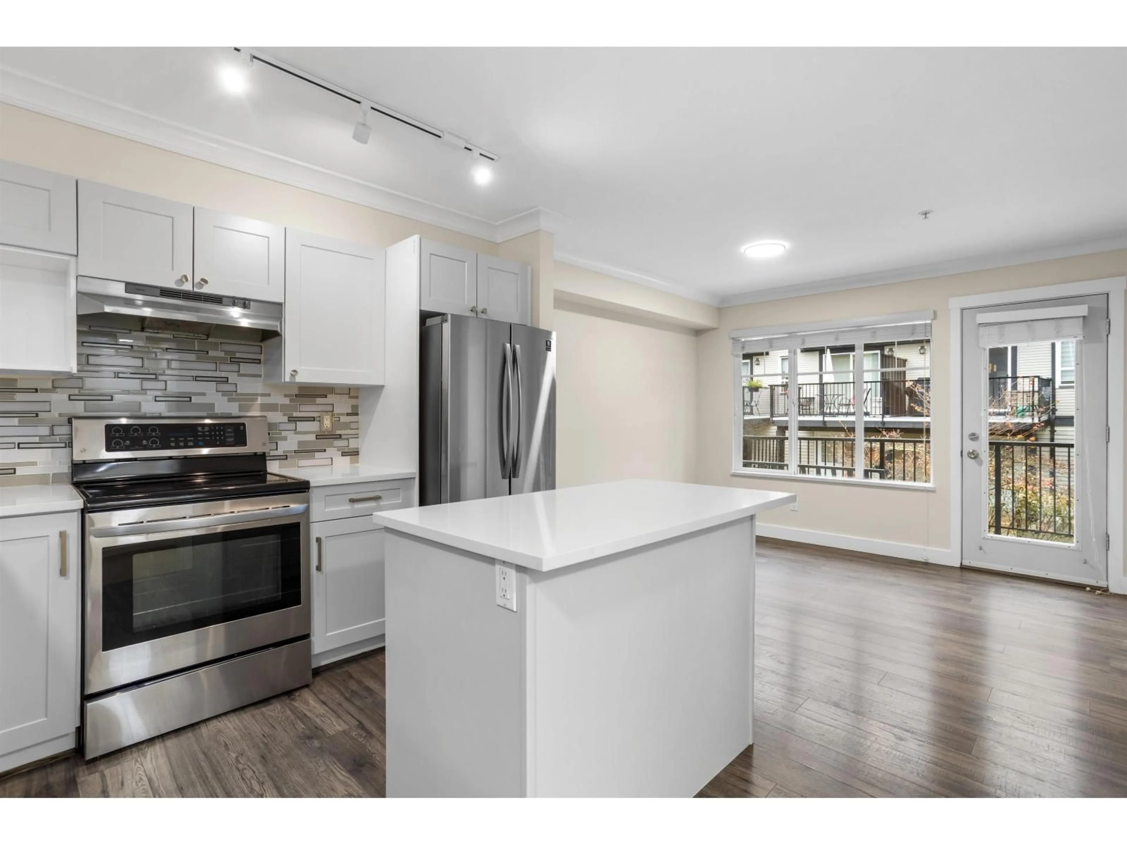 Open concept kitchen, wood/laminate floor for 67 - 6651 203 STREET, Langley British Columbia V2Y2Z2