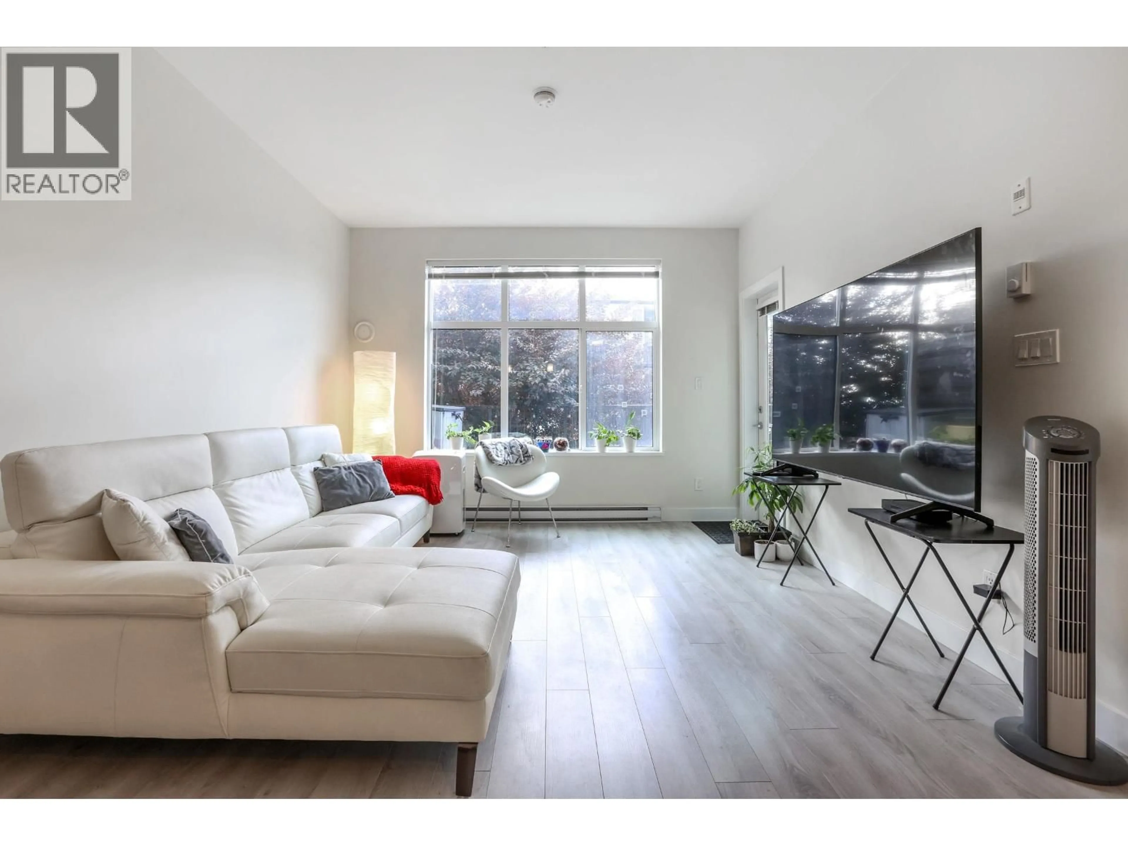 Living room with furniture, wood/laminate floor for 106 - 828 GAUTHIER AVENUE, Coquitlam British Columbia V3K0E9