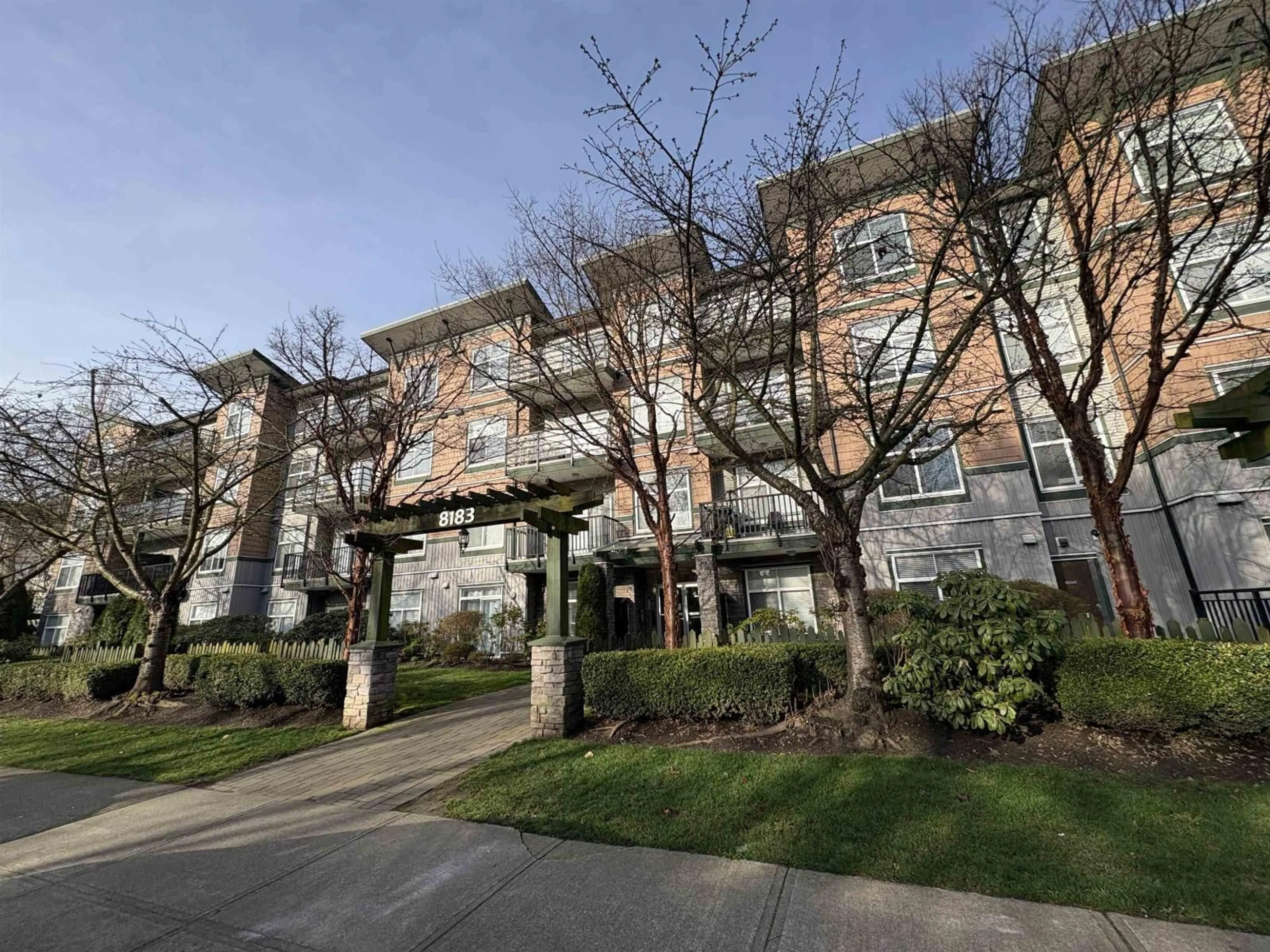 A pic from outside/outdoor area/front of a property/back of a property/a pic from drone, street for 409 - 8183 121A STREET, Surrey British Columbia V3W1S7