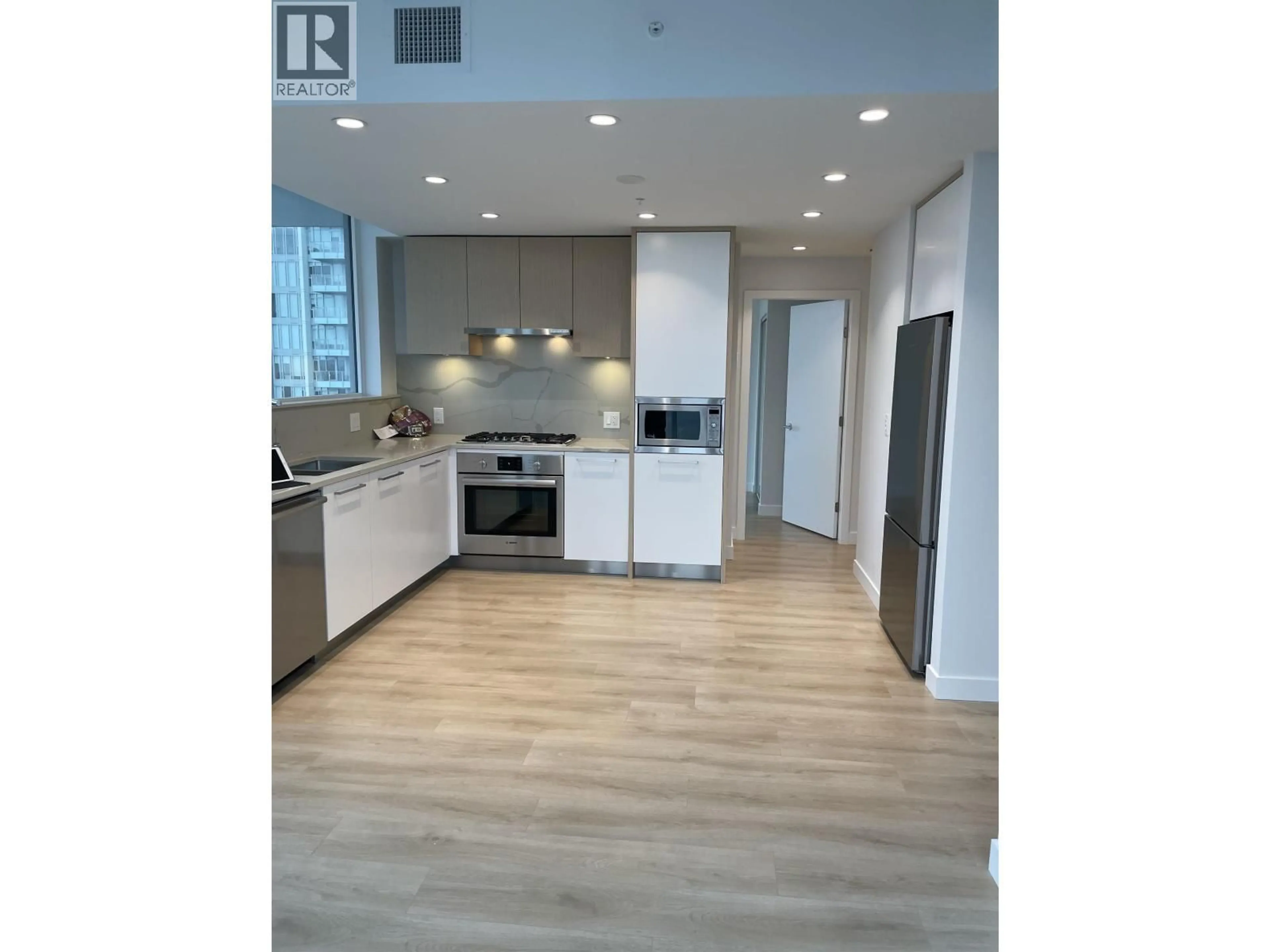 Open concept kitchen, wood/laminate floor for 1609 - 567 CLARKE ROAD, Coquitlam British Columbia V3J0K7