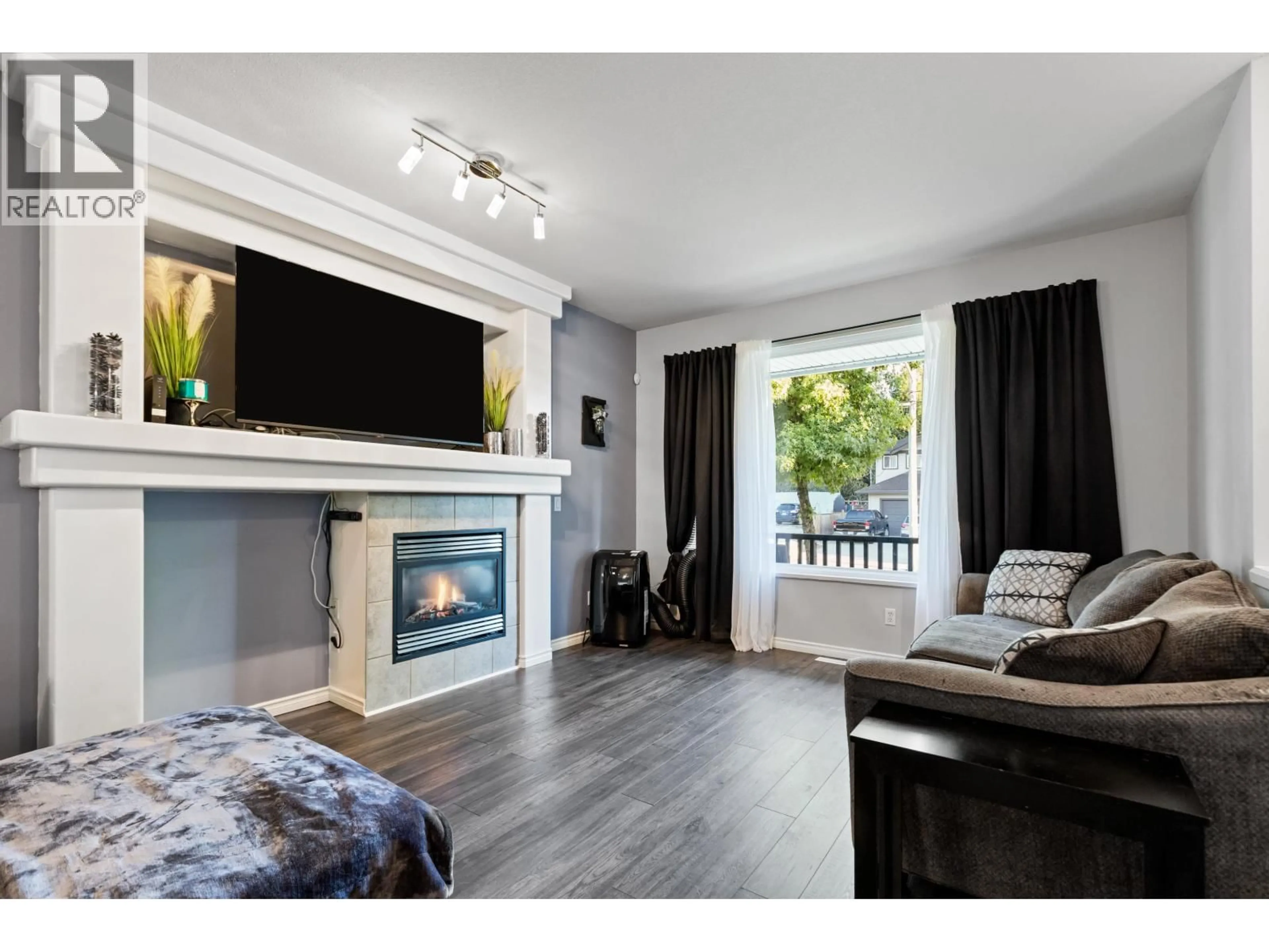 Living room with furniture, wood/laminate floor for 24107 102 AVENUE, Maple Ridge British Columbia V2W2A2