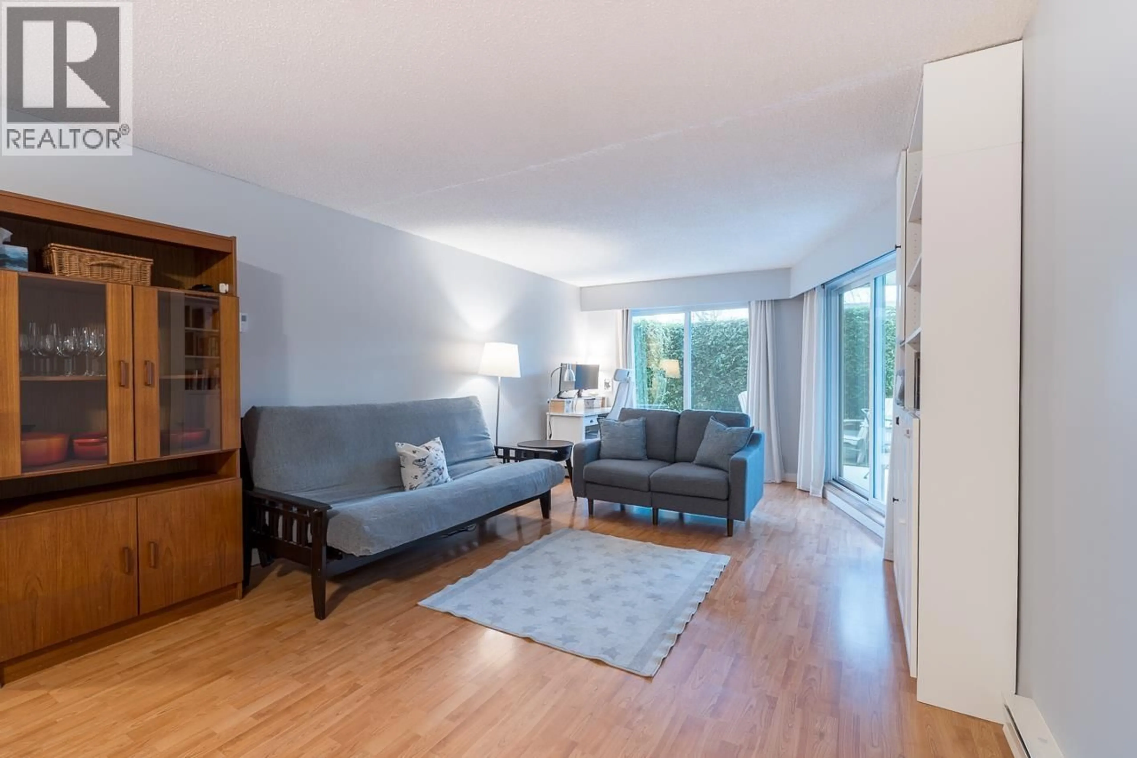 Living room with furniture, wood/laminate floor for 103 - 3353 HEATHER STREET, Vancouver British Columbia V5Z3K6